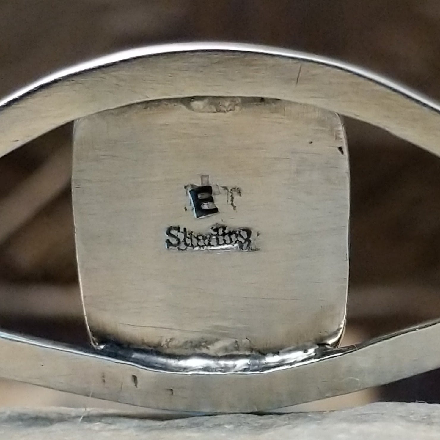 Close-up of the artisan's stamped signature.