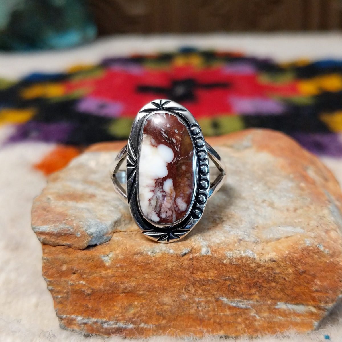 Navajo Wild Horse Ring by P. with elongated stone and stamped silver setting.
