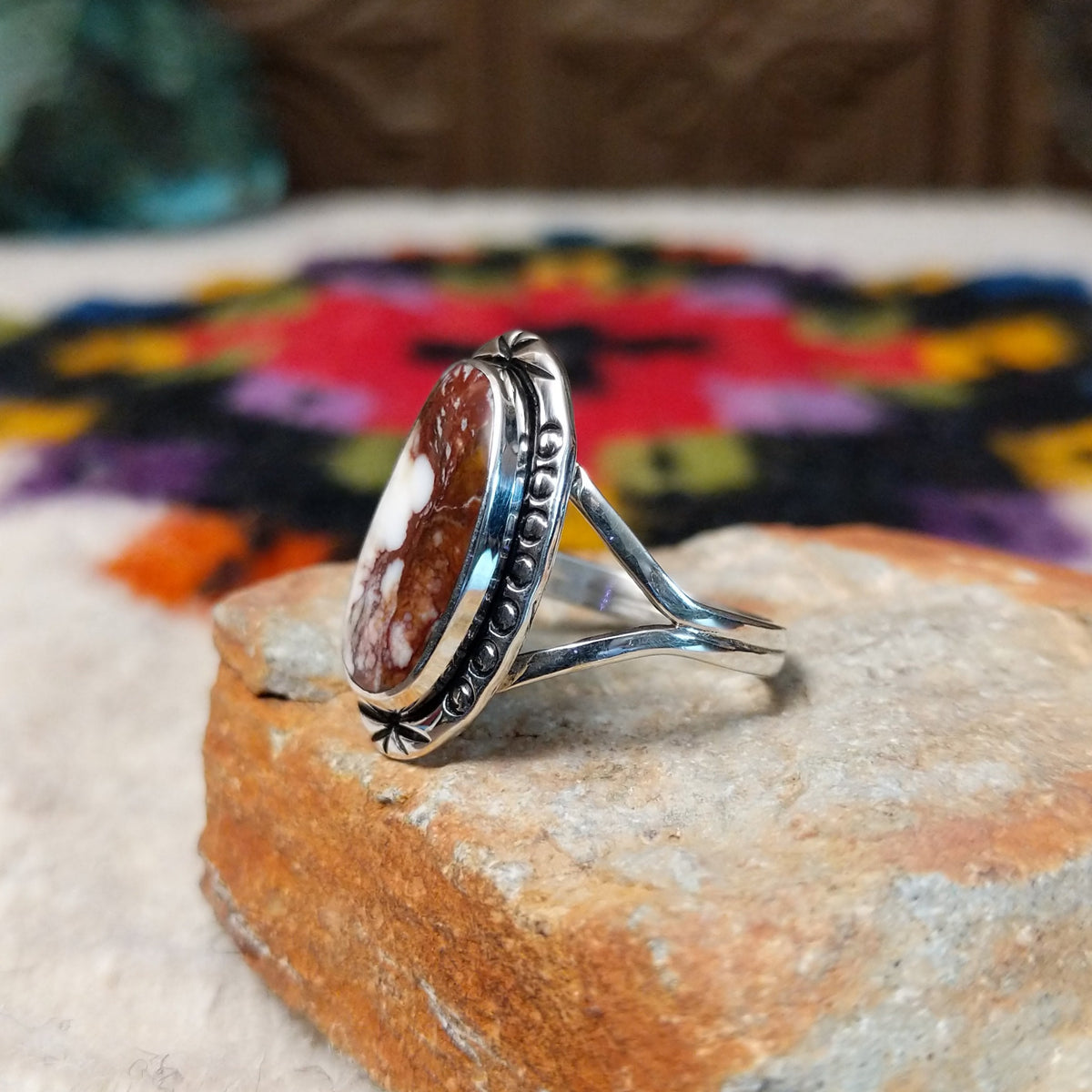 Navajo Wild Horse Ring by P. with elongated stone and stamped setting.