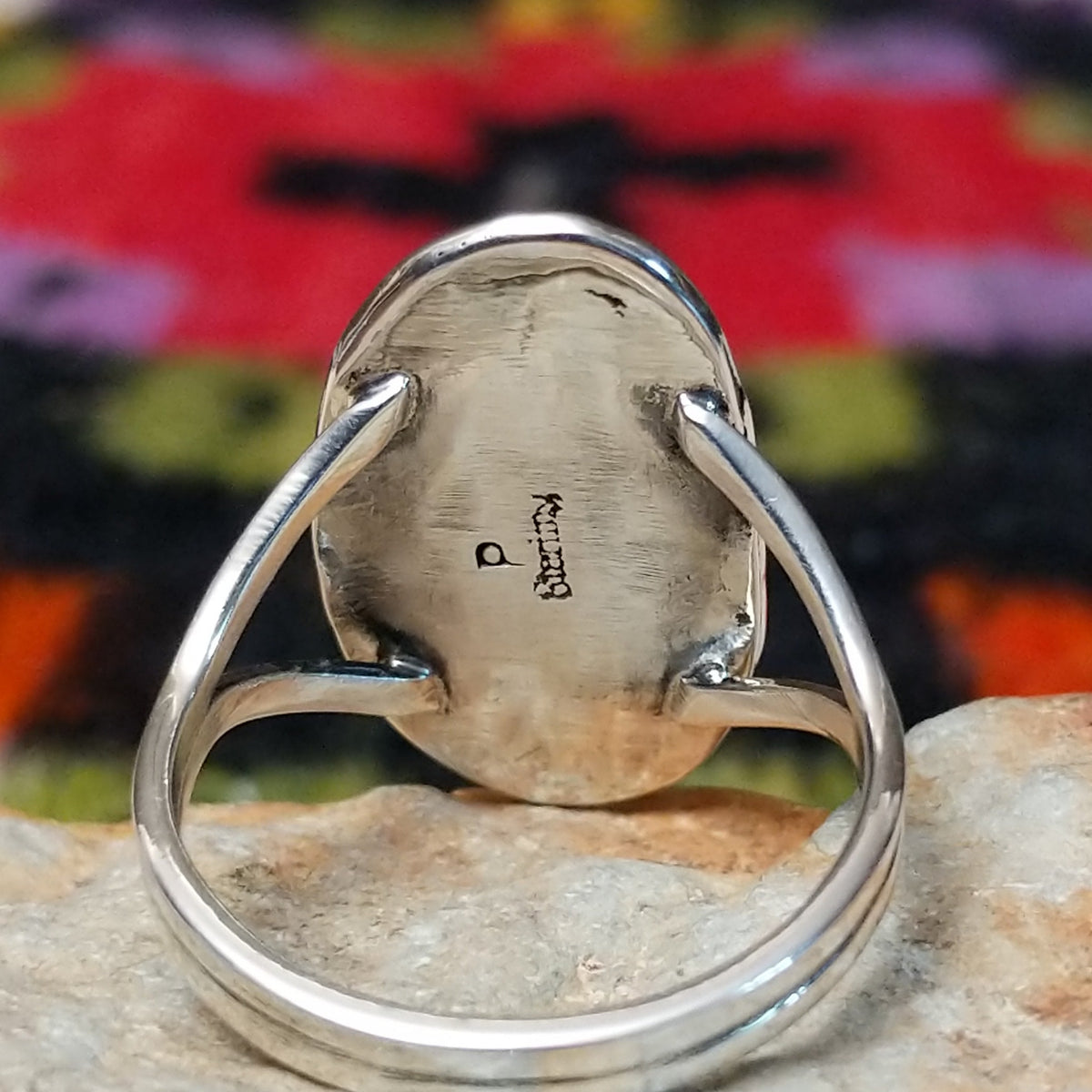 Navajo Wild Horse Ring by P. with elongated stone and stamped setting. Close up of the artist's stamped signature.