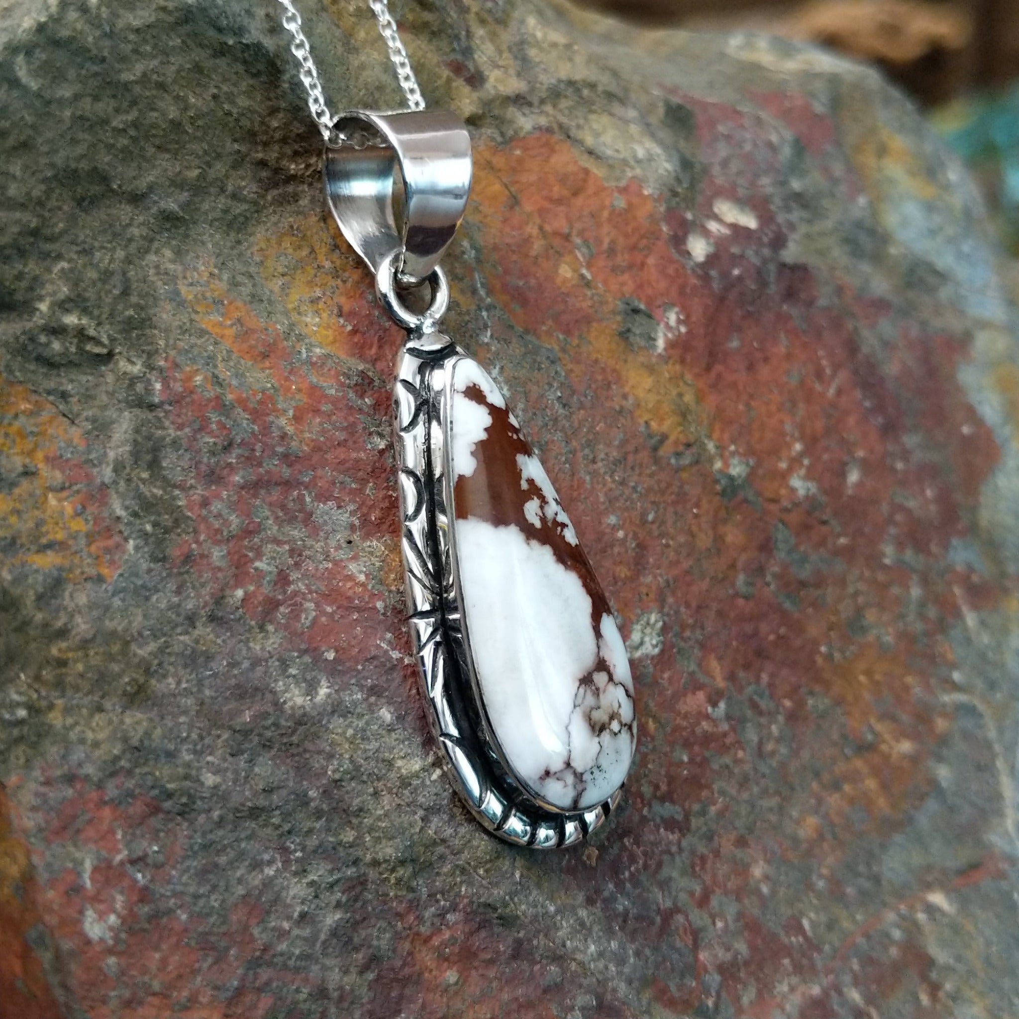 Handcrafted sterling silver Navajo Wild Horse teardrop pendant featuring a natural Wild Horse gemstone in a classic bezel setting; side view.