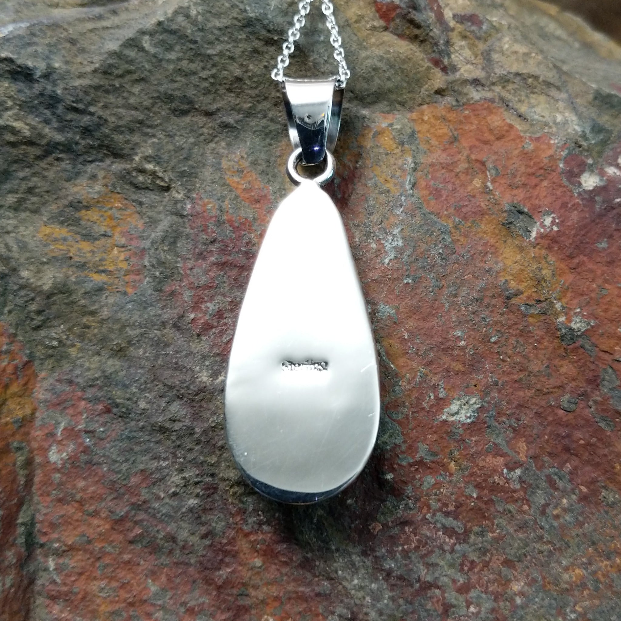 Handcrafted sterling silver Navajo Wild Horse teardrop pendant featuring a natural Wild Horse gemstone in a classic bezel setting; Sterling Silver stamp.