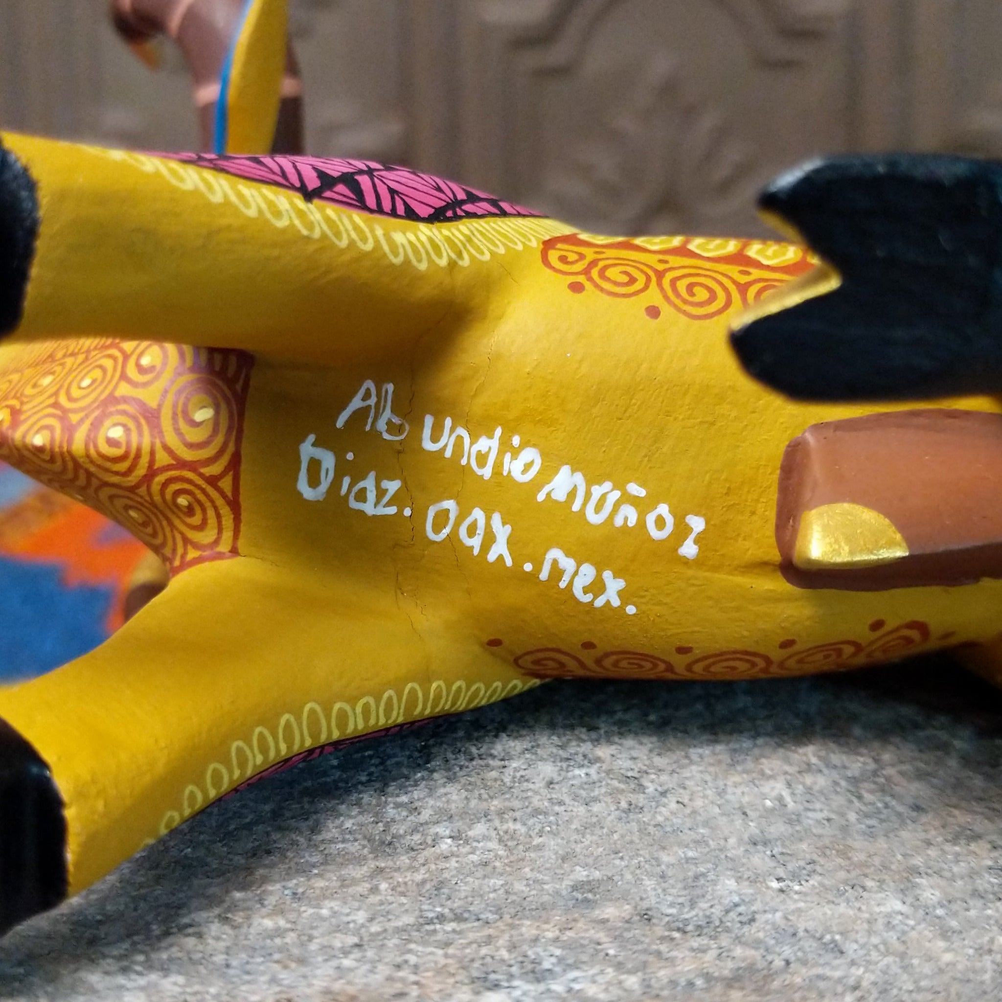 Base of Oaxacan bull wood carving signed by artist Abundio Muñoz of Díaz Ordaz, Oaxaca, Mexico.