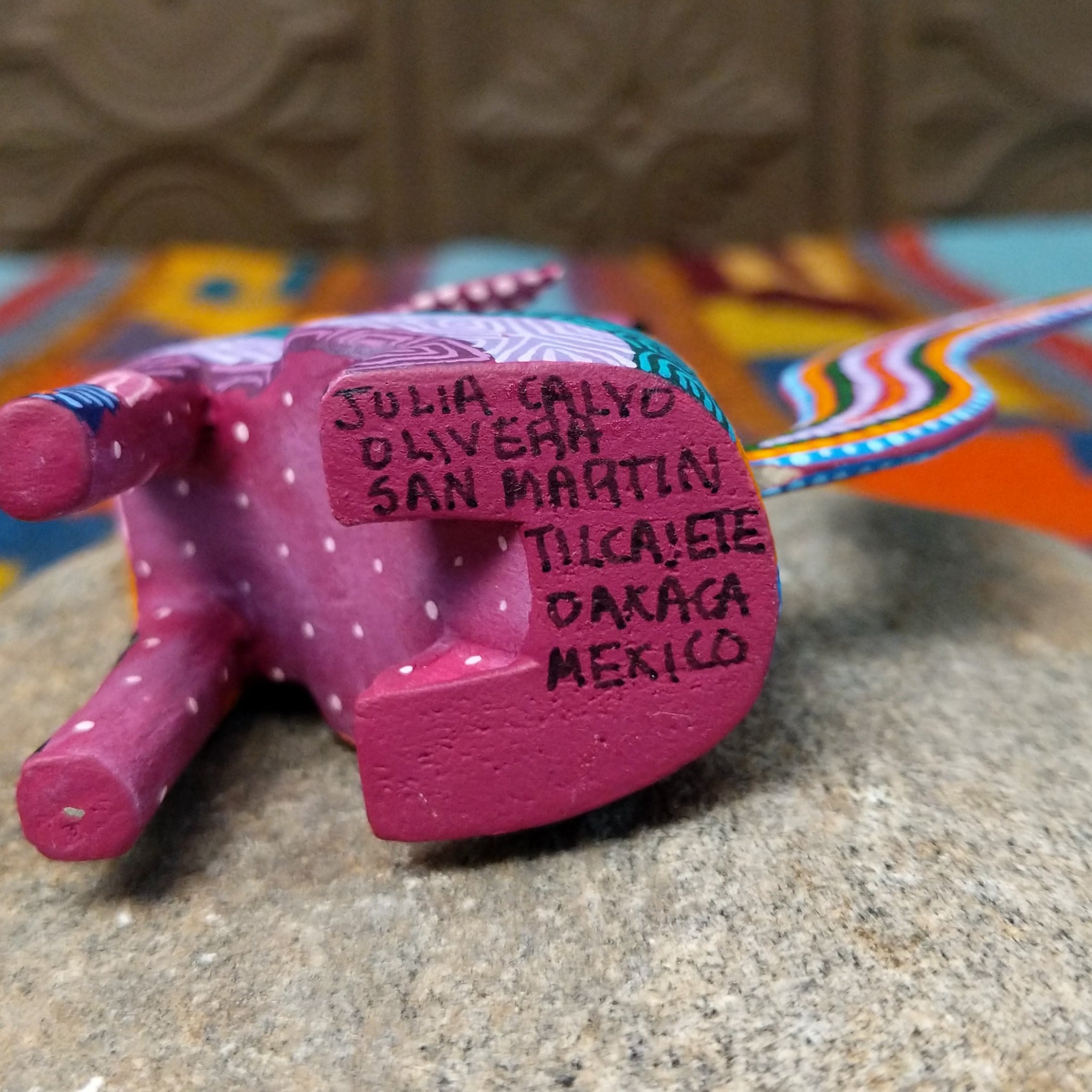 Base of Oaxacan coyote wood carving signed by Julia Calvo Olivera and marked San Martín Tilcajete, Oaxaca, Mexico.