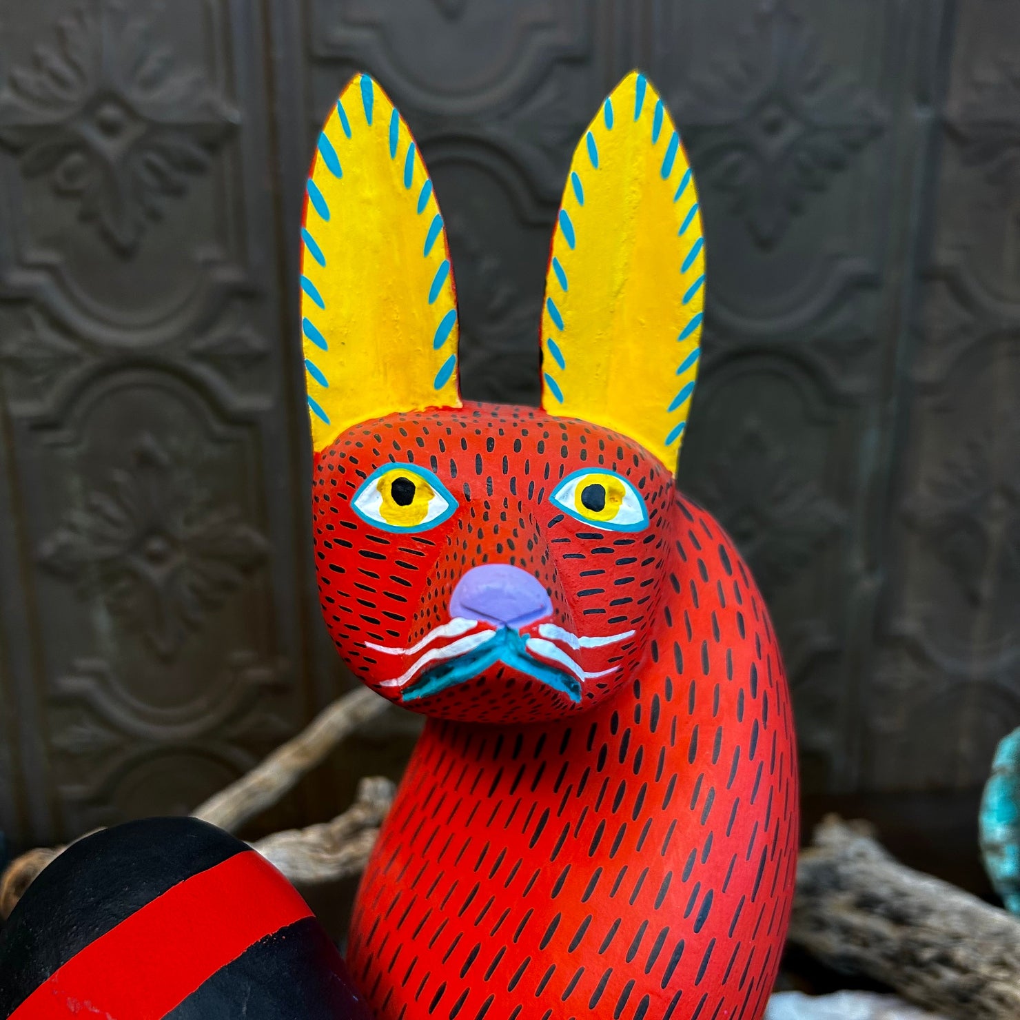 A close-up of the fox’s face with precise yellow stippling around its eyes.