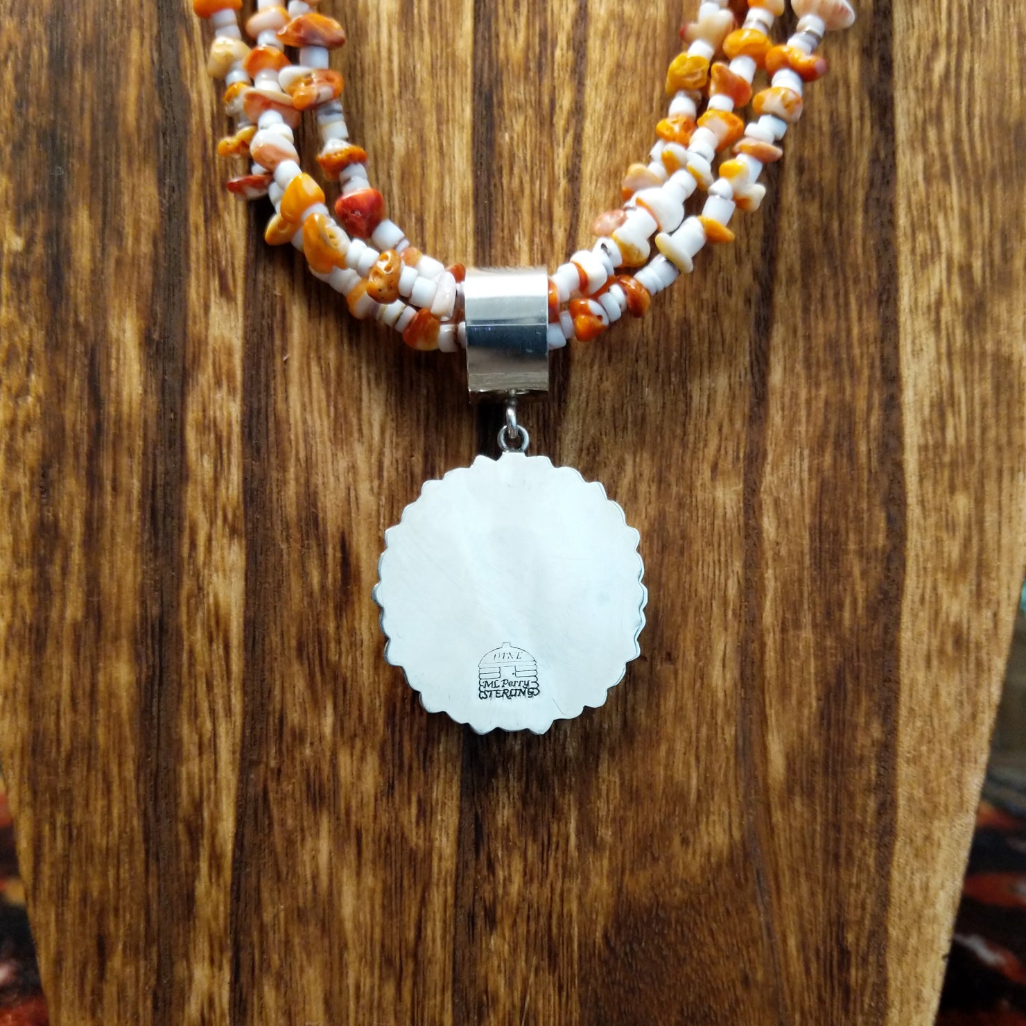 Back of the sterling silver pendant featuring the artists stamp.