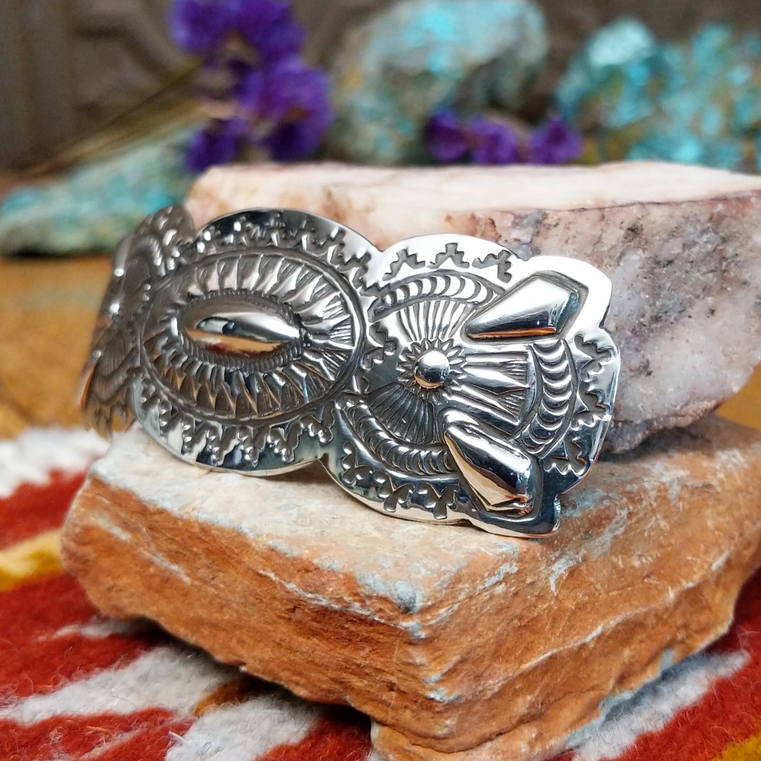 Sterling silver barrette by Harold Tom with ornate stamped silverwork and raised oval center.