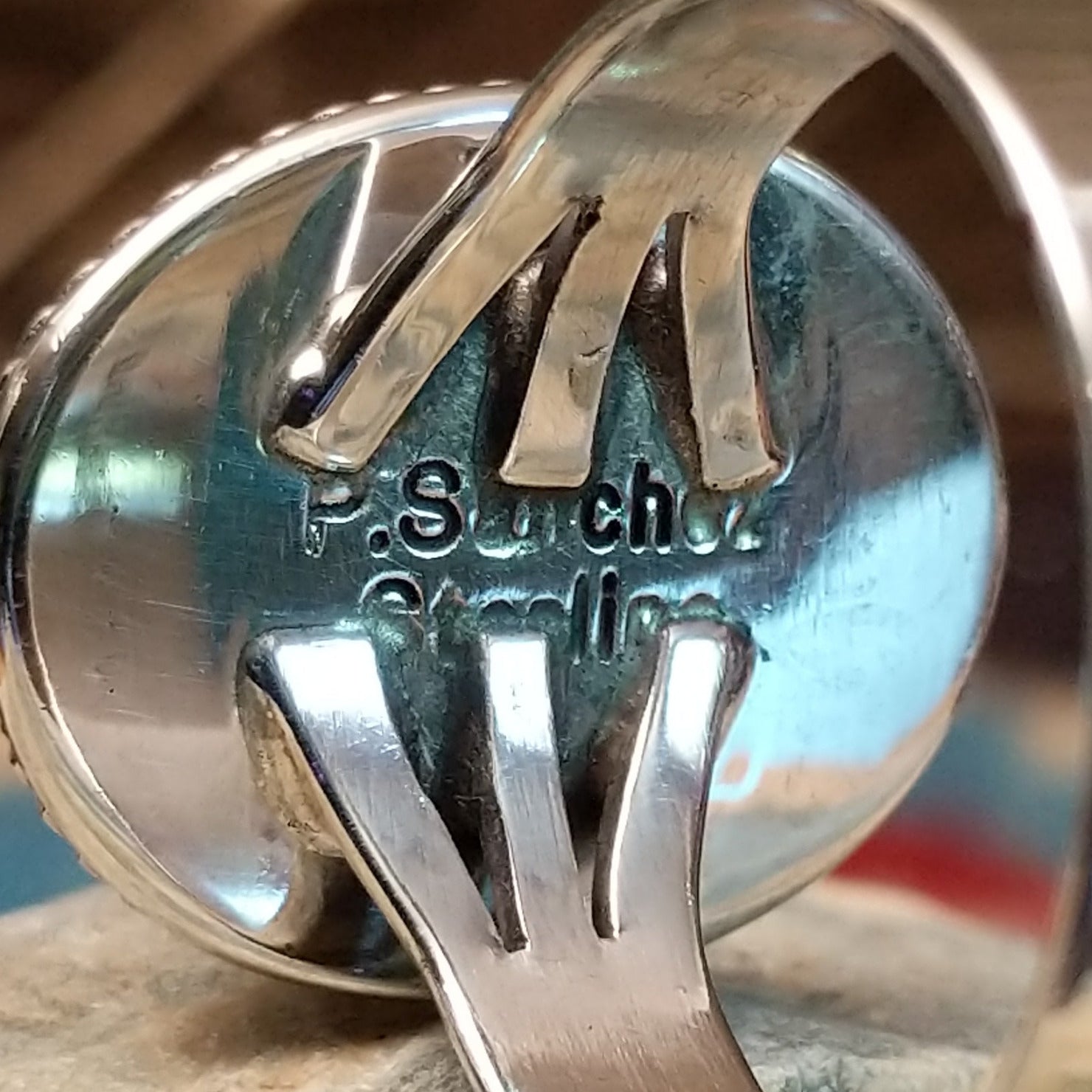 Close-up of the artisan's stamped signature.