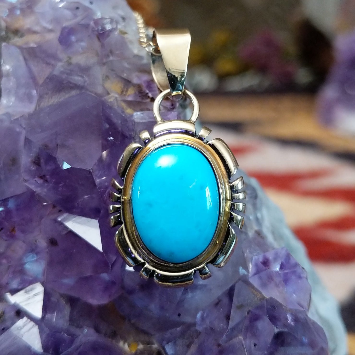 14kt gold Charles Johnson pendant with oval turquoise stone and sculptural gold setting.