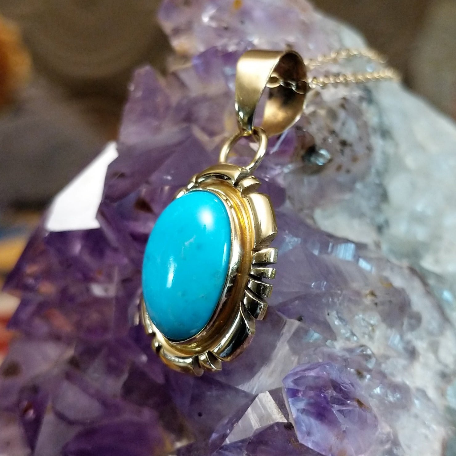 14kt gold Charles Johnson pendant with oval turquoise stone and sculptural gold setting.