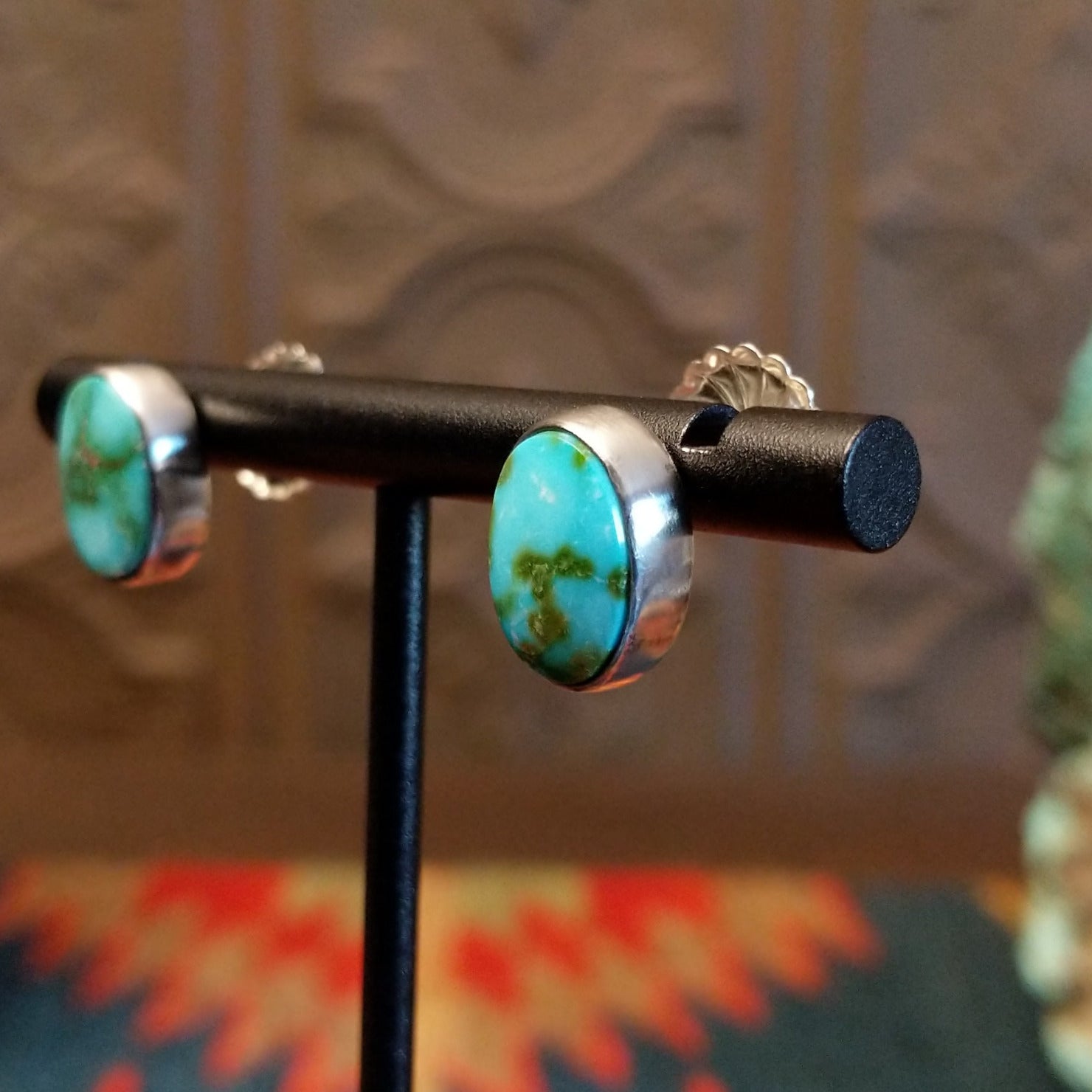Sterling silver earrings with sonoran gold turquoise set in oval bezels.