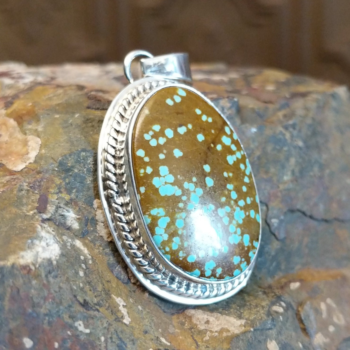 Handcrafted by Navajo artist L.P., this oval pendant features genuine #8 Turquoise set in sterling silver.