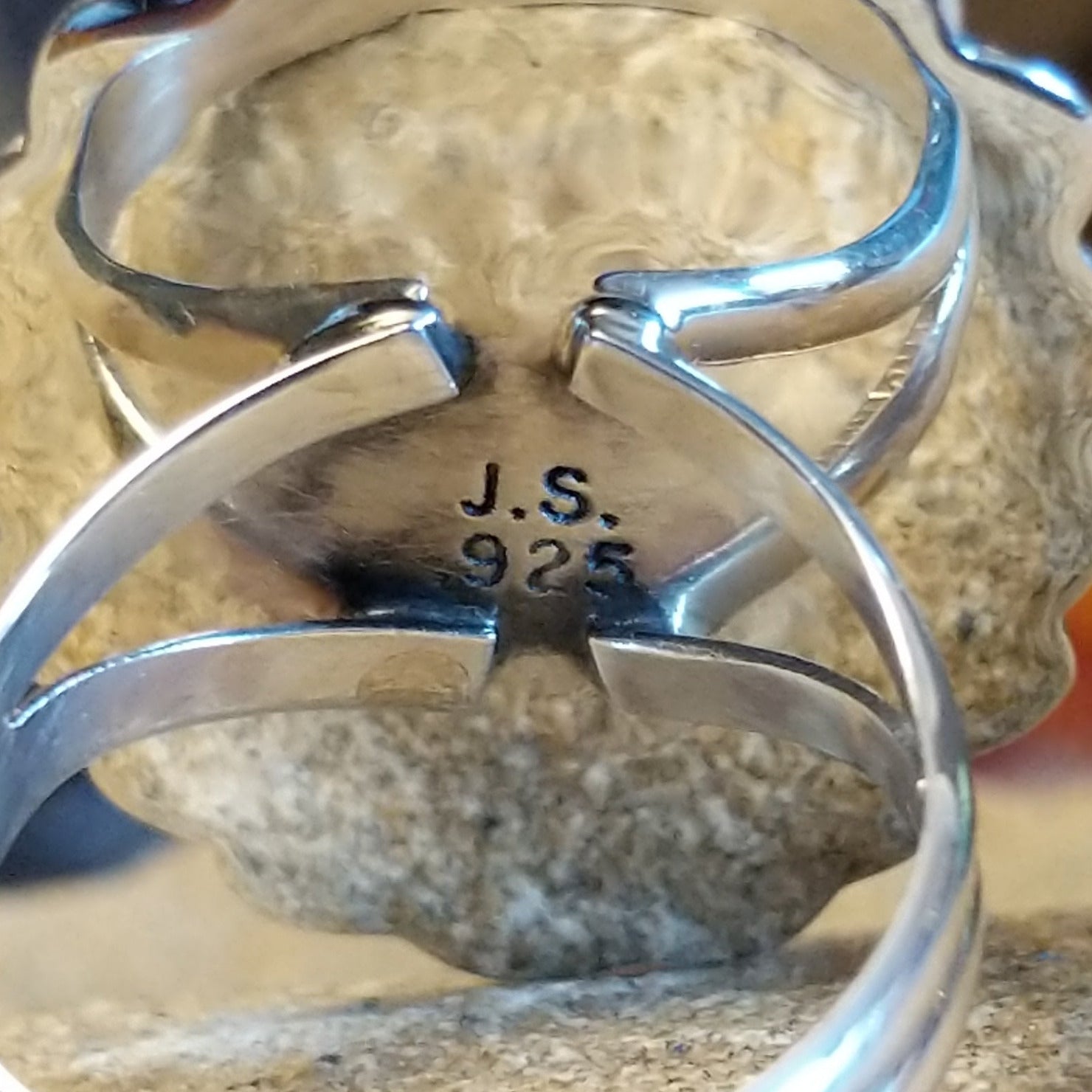 Silver ring with 'J.S.' and '925' artisan hallmarks on back
