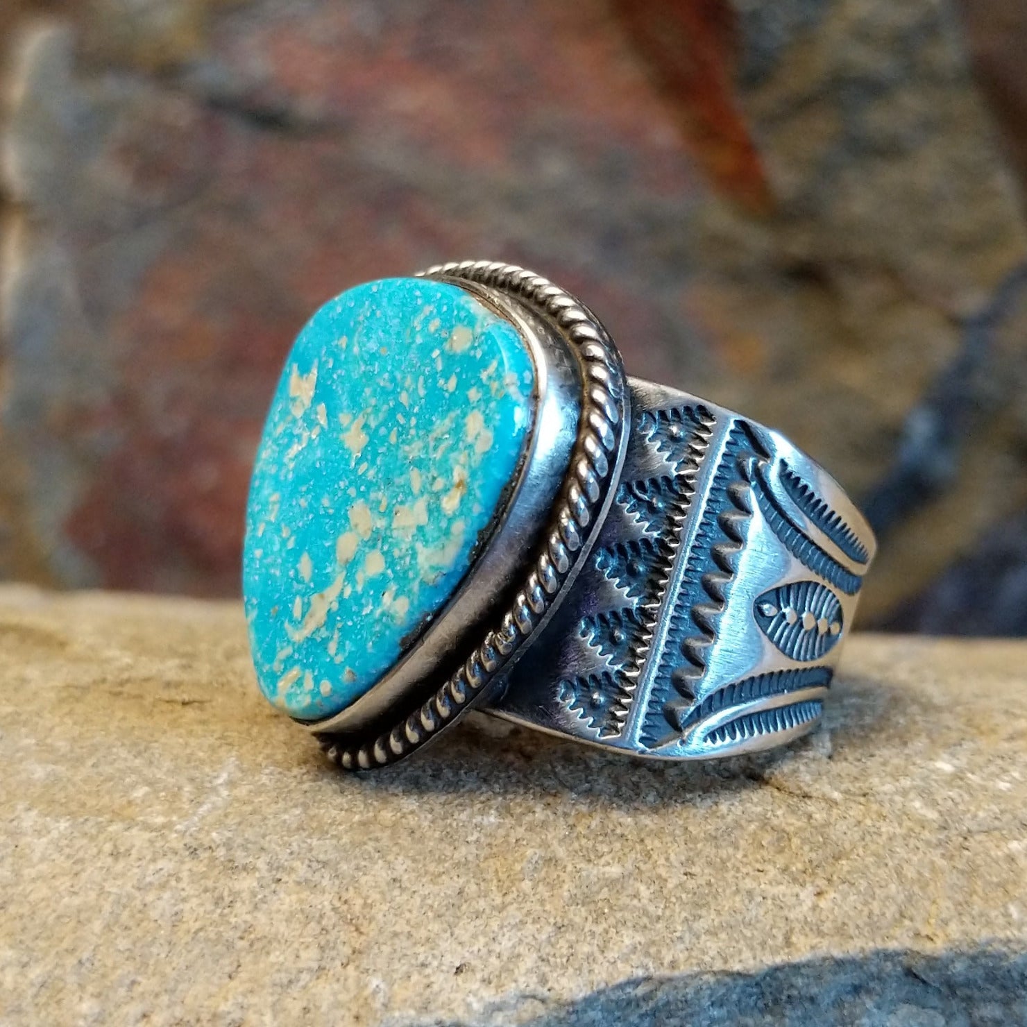 Navajo triangular turquoise ring by L.P., handcrafted in sterling silver; size 14 side view.