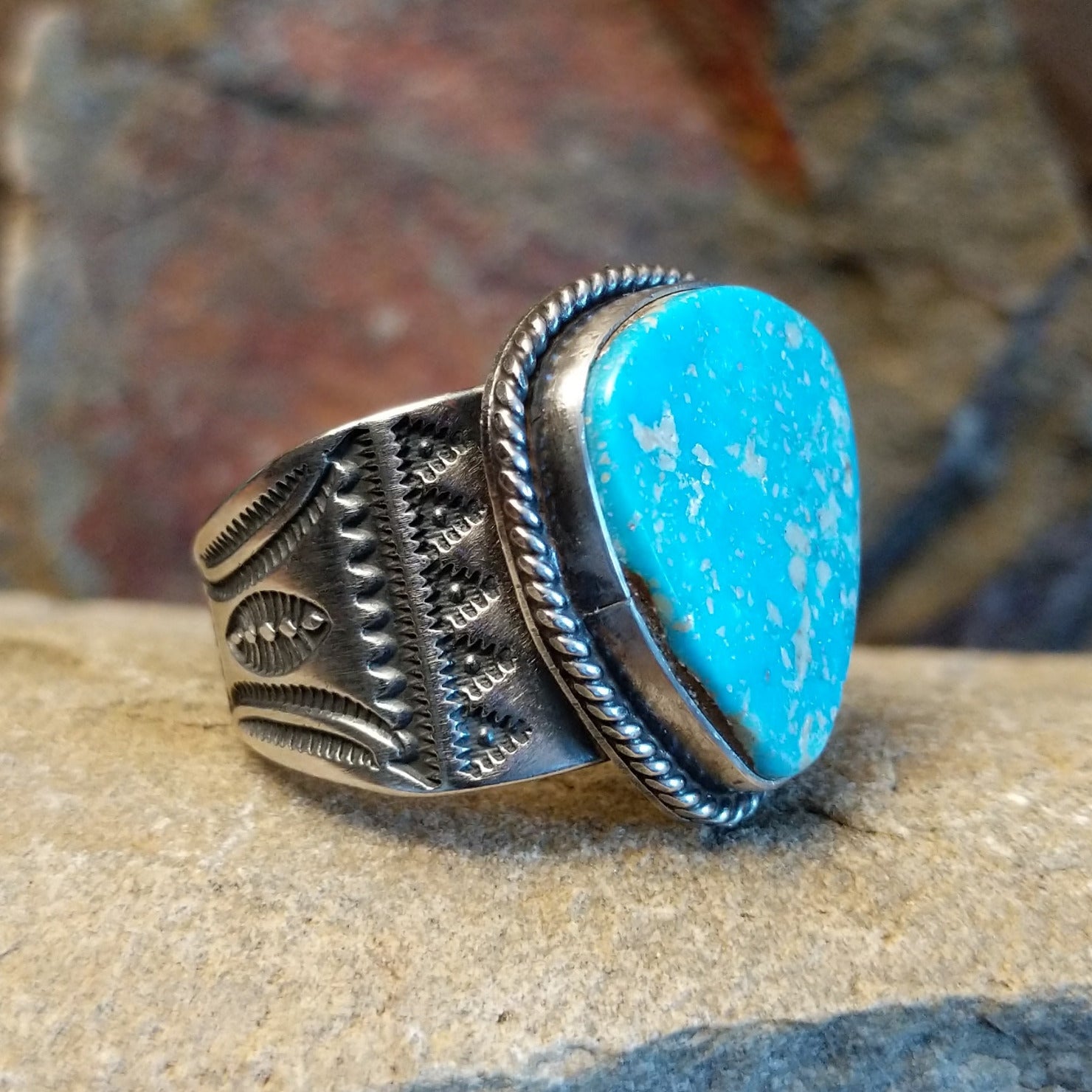 Navajo triangular turquoise ring by L.P., handcrafted in sterling silver; size 14 side view.