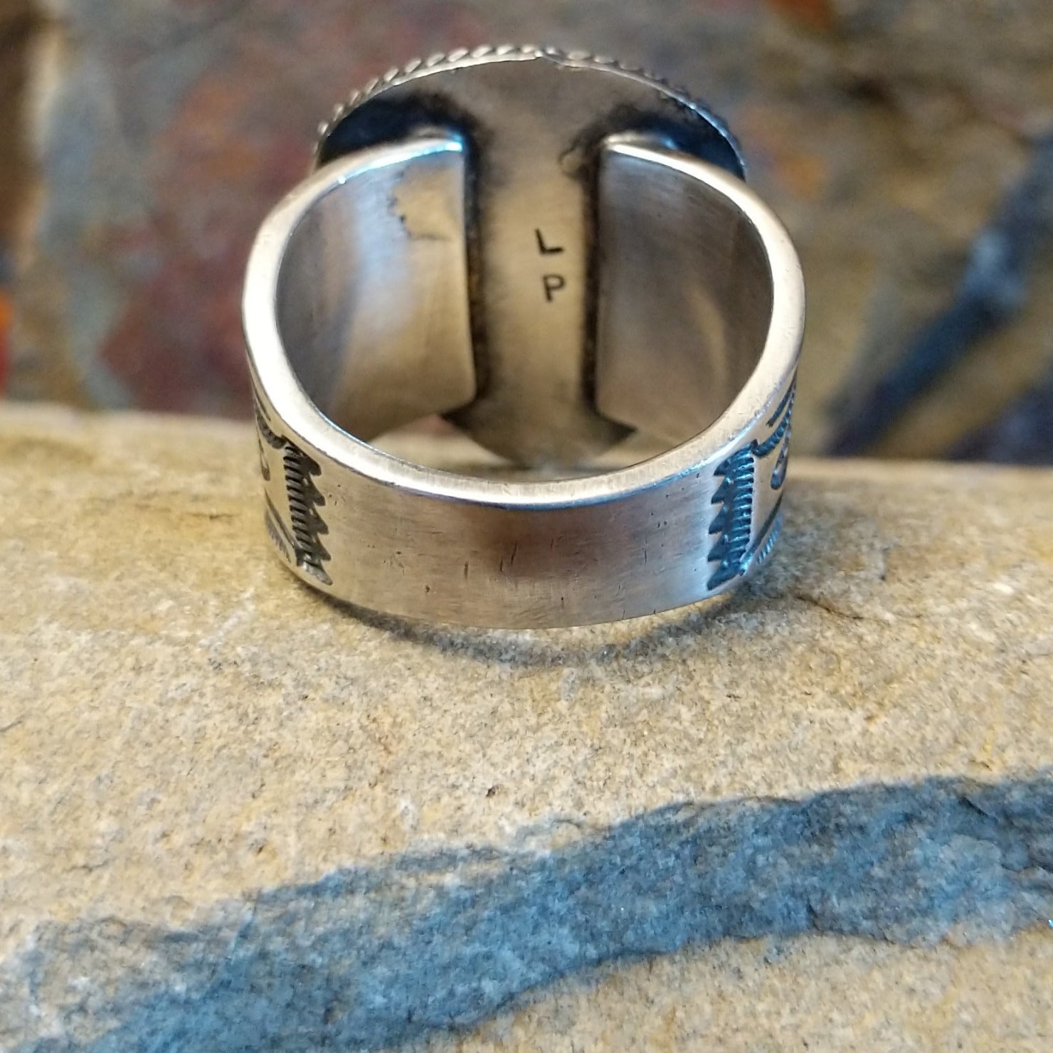 Artisan stamp on underside of ring.
