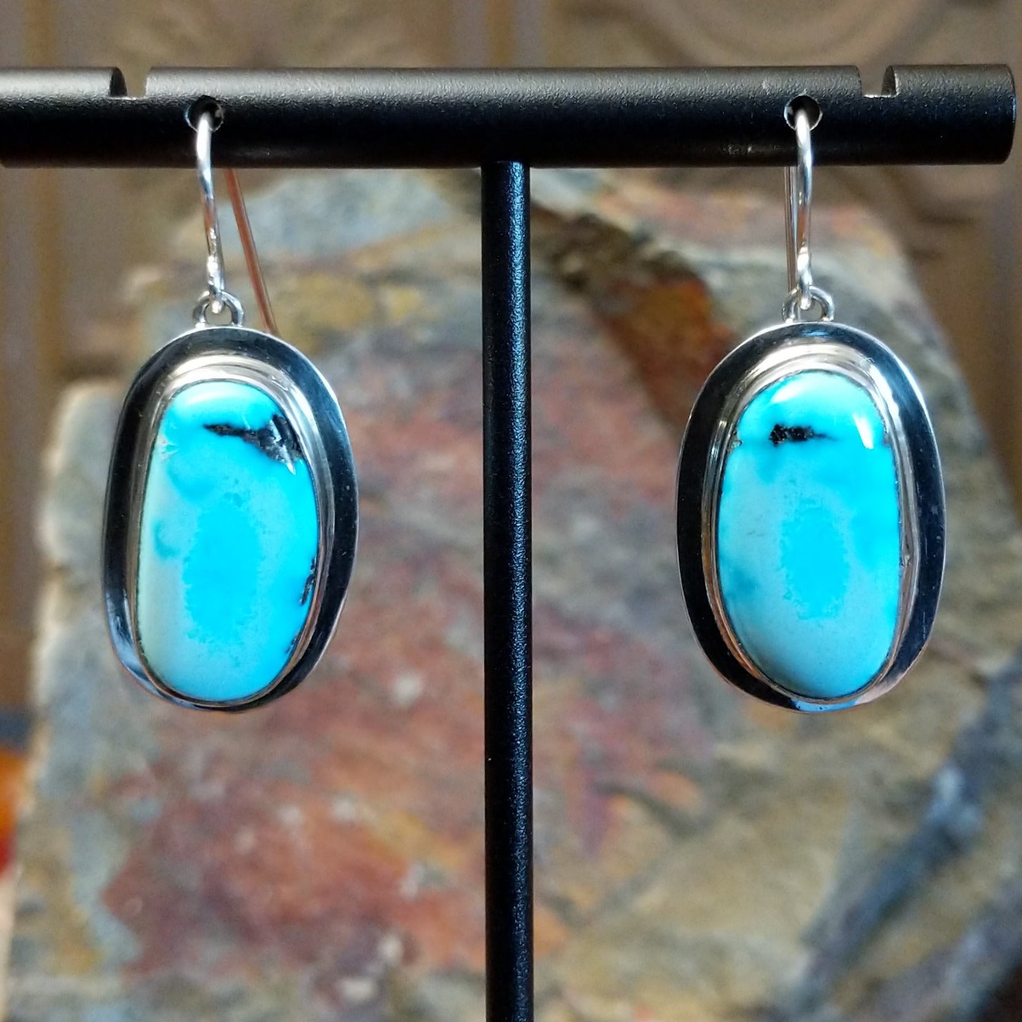 Framed turquoise earrings by Navajo artist Chris Billie, handcrafted in sterling silver.