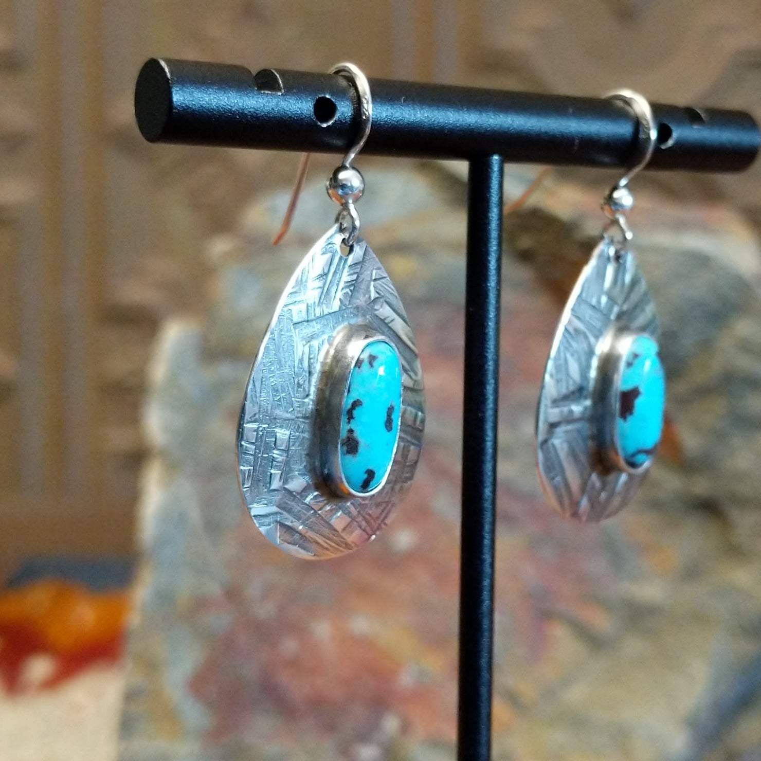 Kingman turquoise earrings by Navajo artists Everett & Mary Teller in planished sterling silver, side view.
