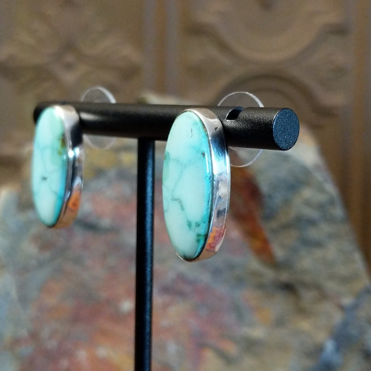 Turquoise Mountain turquoise ellipse earrings by Navajo artist Ann Curley, side view.