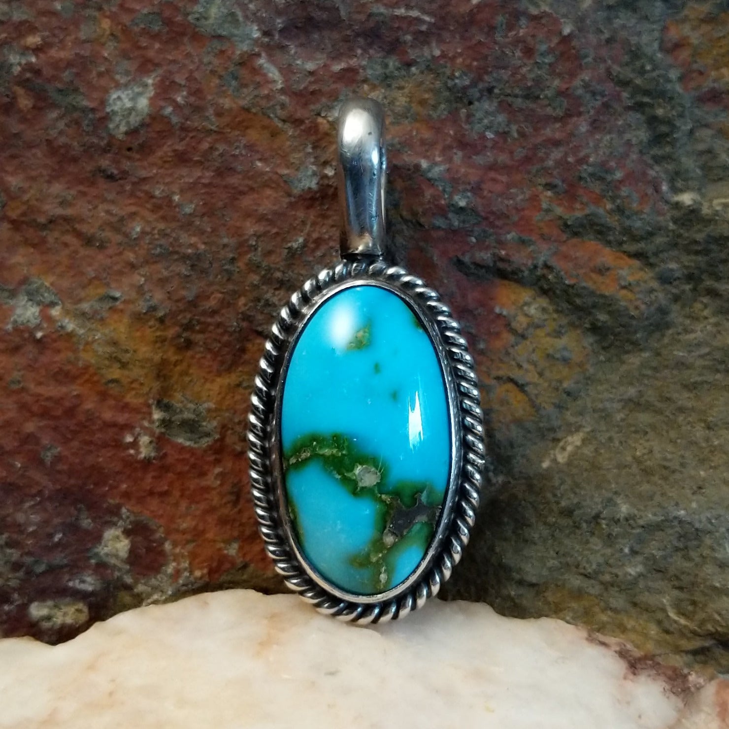 Sonoran Gold turquoise oval pendant by Navajo artist Lowell Draper, handcrafted in sterling silver with rope setting.