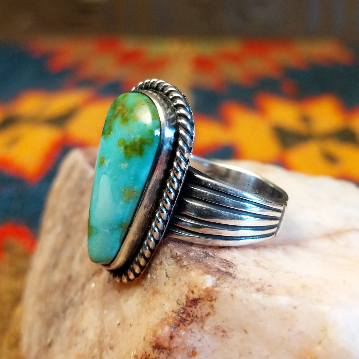 Sonoran Gold Turquoise ovate shaped stone set in sterling silver. Created by Murphy Platero, size 6.5 side view.