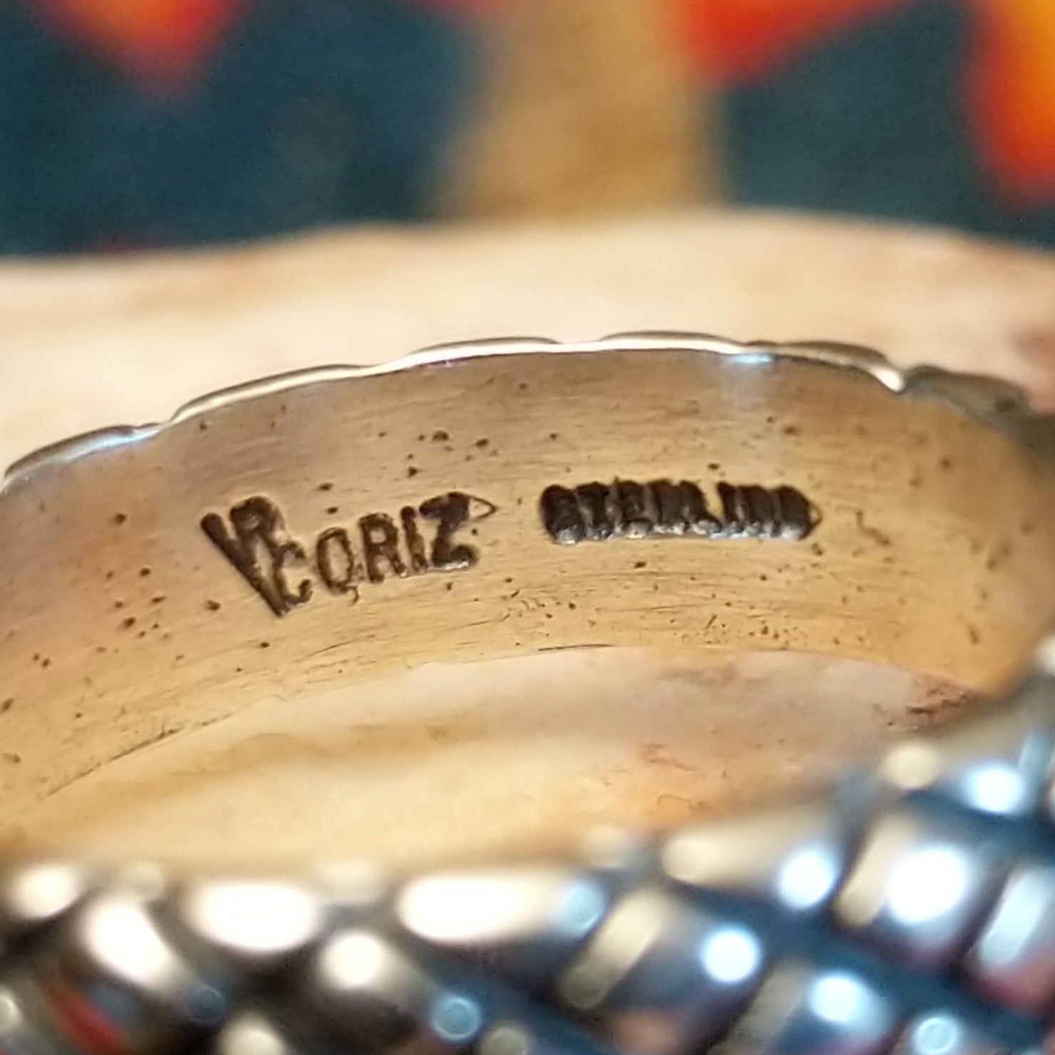 Artisan and Sterling Silver stamp on inner band of ring.