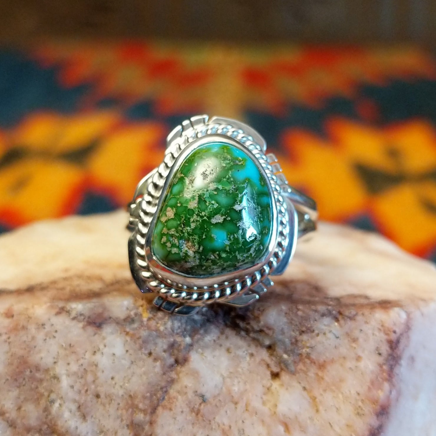 Sonoran Gold Turquoise stone set in etched sterling silver, with a classic rope design. Made by Jake Sampson, this ring is size 8, front view.