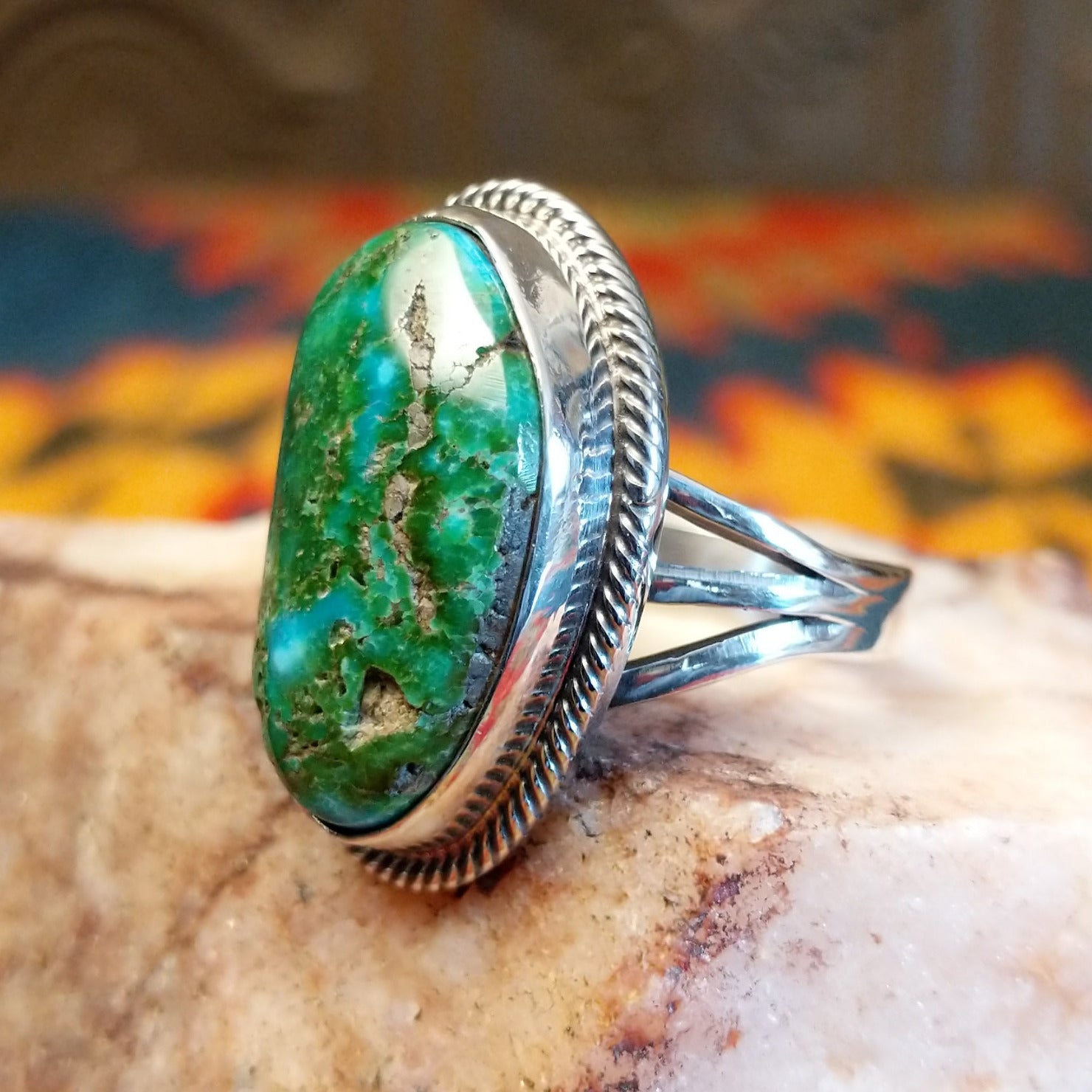 Sonoran Gold Turquoise stone set in a classic trifurcate sterling silver band. Made by Roie Jaque, this ring is size 10, side view.