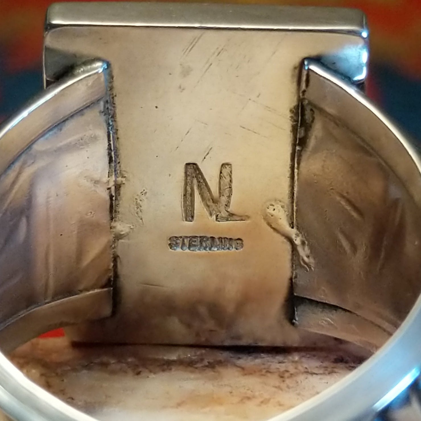 Artisan and Sterling Silver stamp on underside of ring.