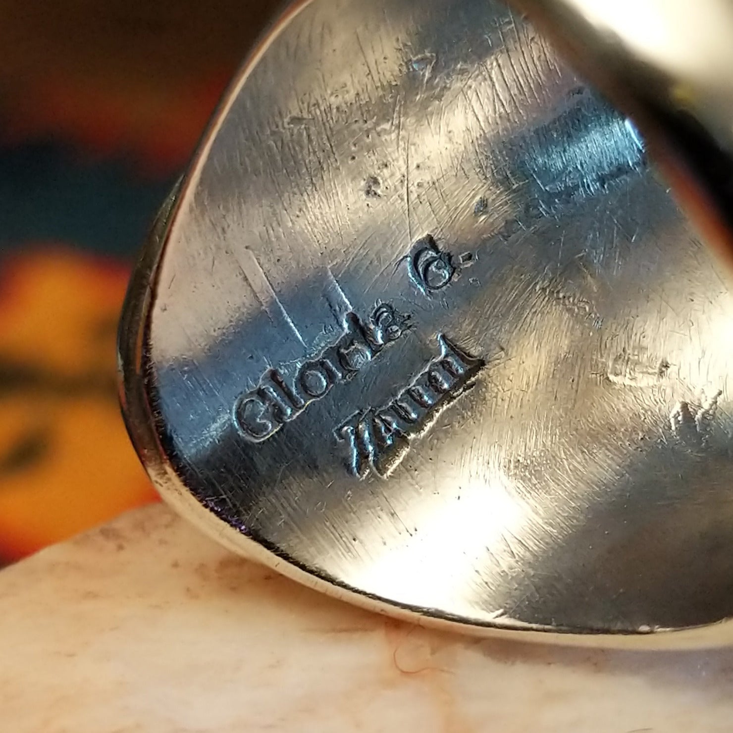 Artisan stamp on underside of ring.