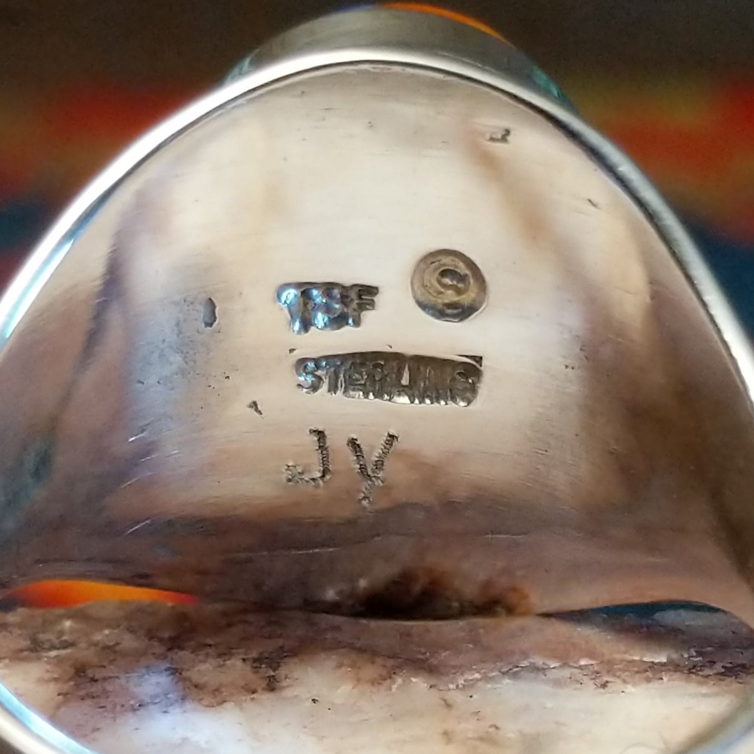 Artisan and Sterling Silver stamp on underside of ring.