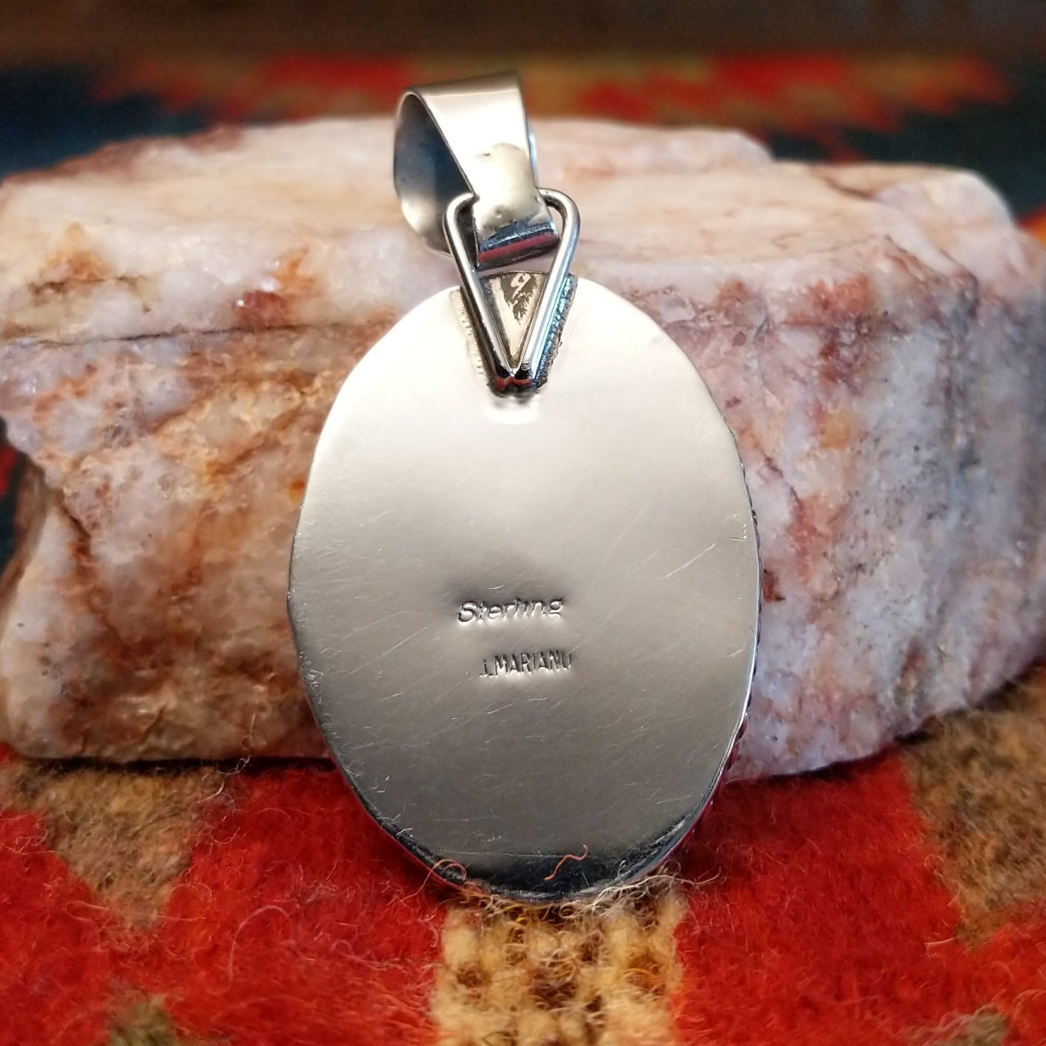Artisan and Sterling Silver stamp on back of pendant.