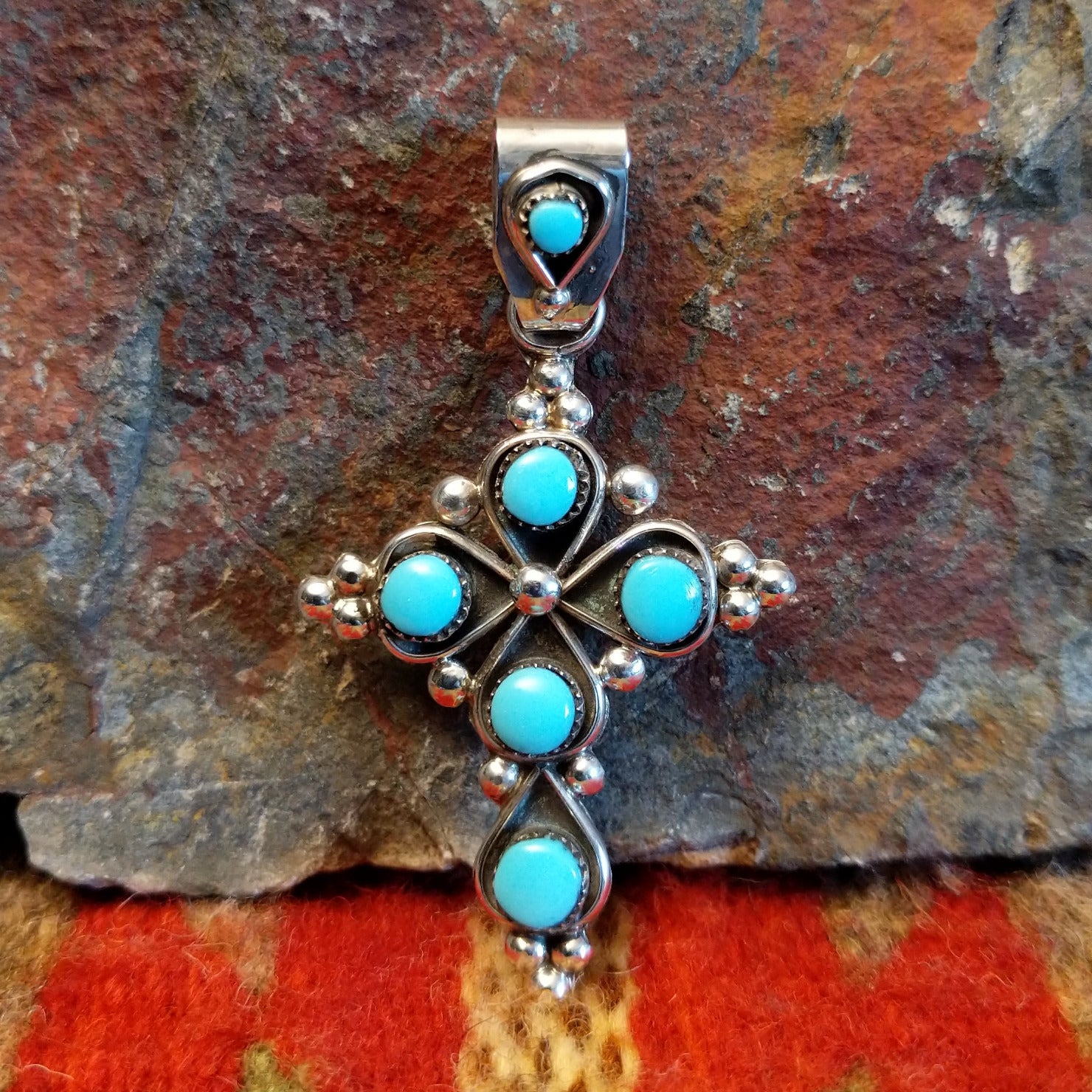 Sterling silver cross pendant with snake eye turquoise stones by Zuni artisan L.B.