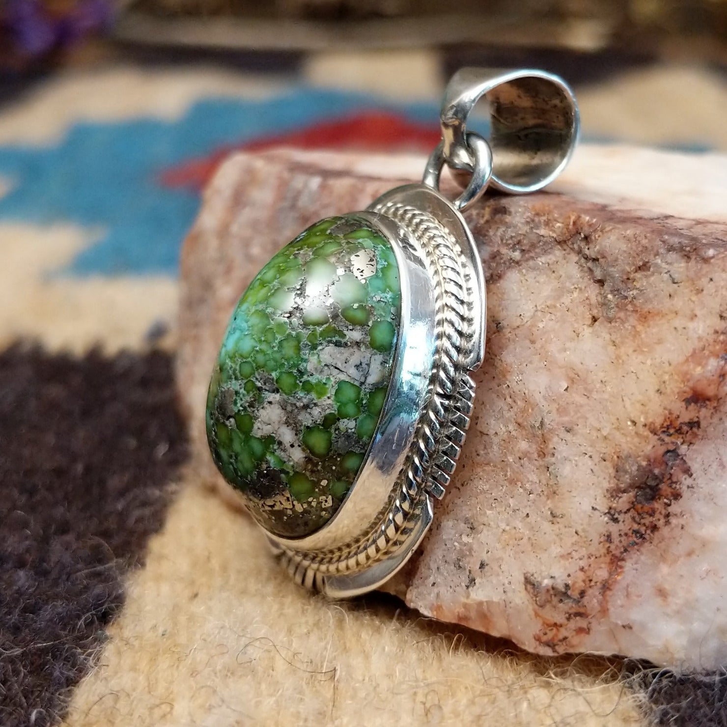 Domed sterling silver pendant featuring a polished Sonoran Gold turquoise stone with blue-green coloring and natural golden matrix, handcrafted by Navajo artist Burt Francisco. Side View