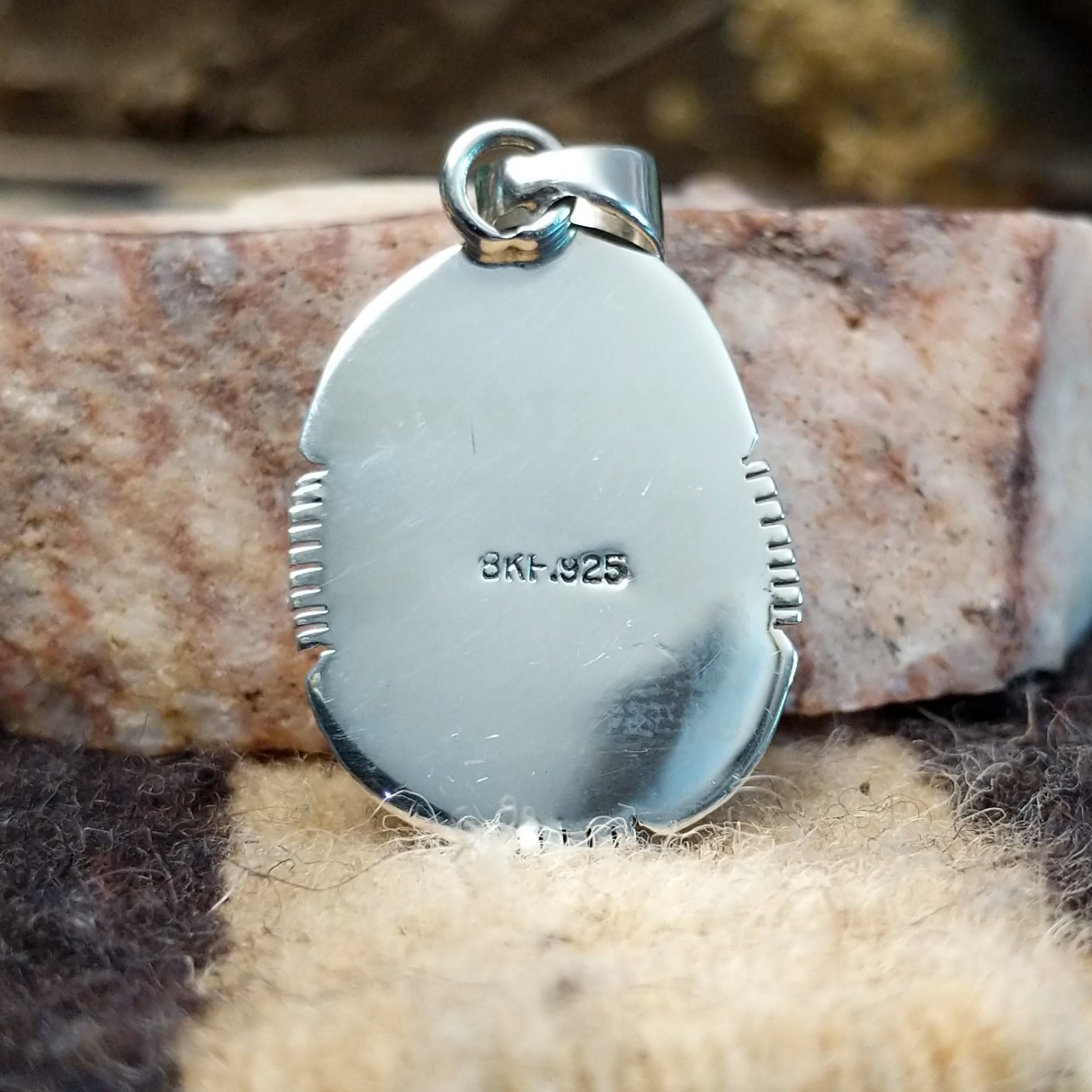 Domed sterling silver pendant featuring a polished Sonoran Gold turquoise stone with blue-green coloring and natural golden matrix, handcrafted by Navajo artist Burt Francisco. Back view with artisan and silver stamp.