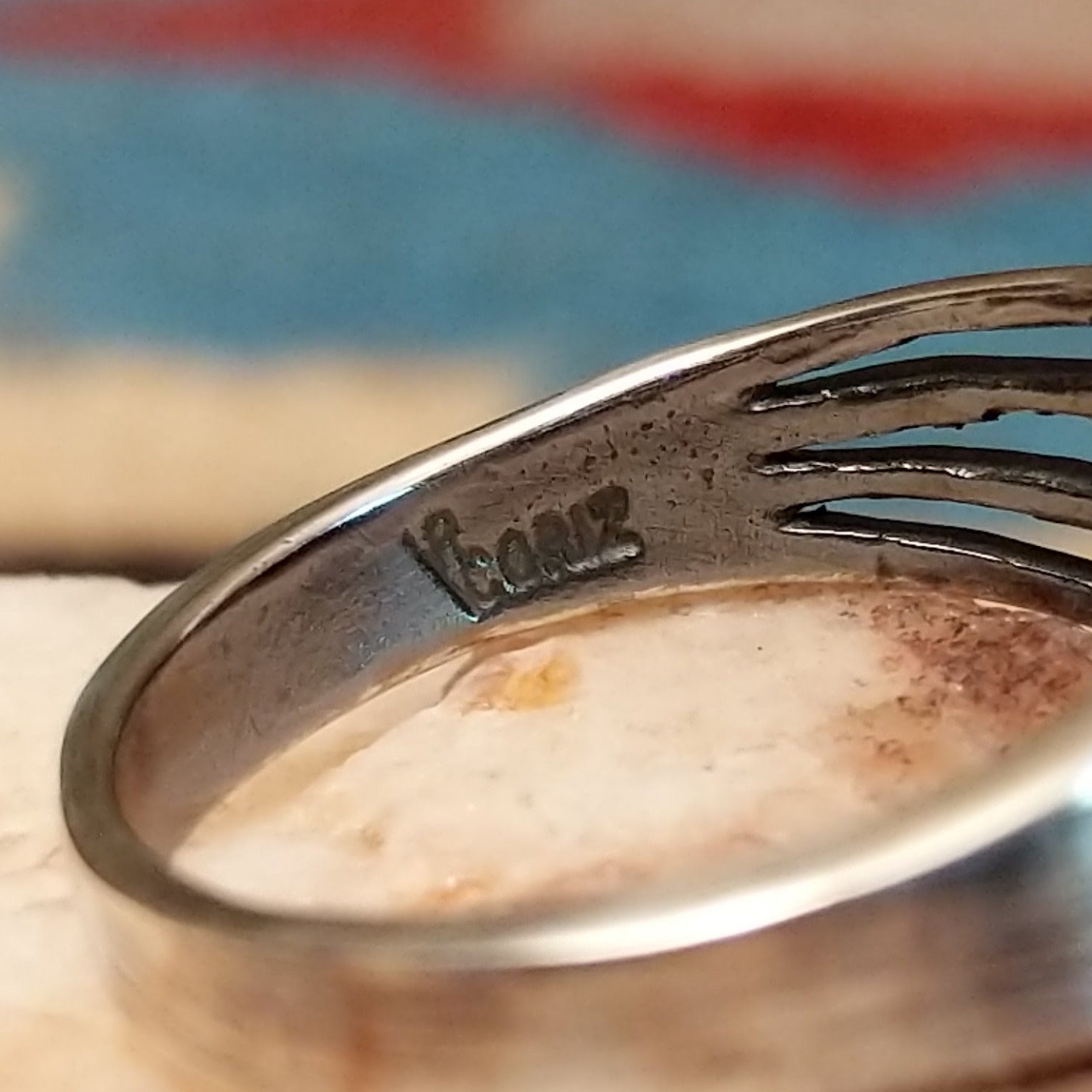 Sterling silver split-band ring by Raymond Coriz featuring a polished black onyx stone in a sleek Southwestern design. Artisan stamp.