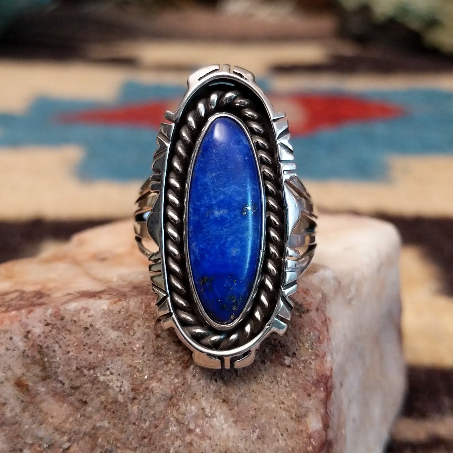 Sterling silver navette ring by Verdy Jake featuring a deep blue lapis stone in a classic Southwestern design. Front view.