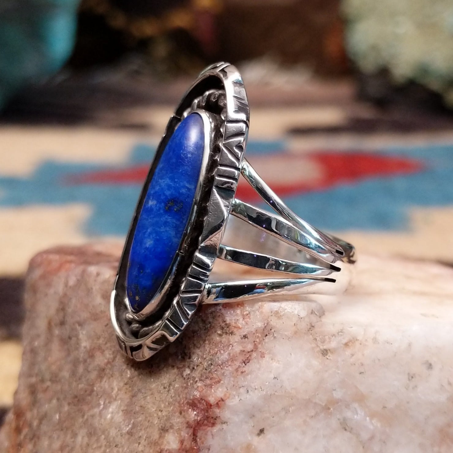 Sterling silver navette ring by Verdy Jake featuring a deep blue lapis stone in a classic Southwestern design. Side view.