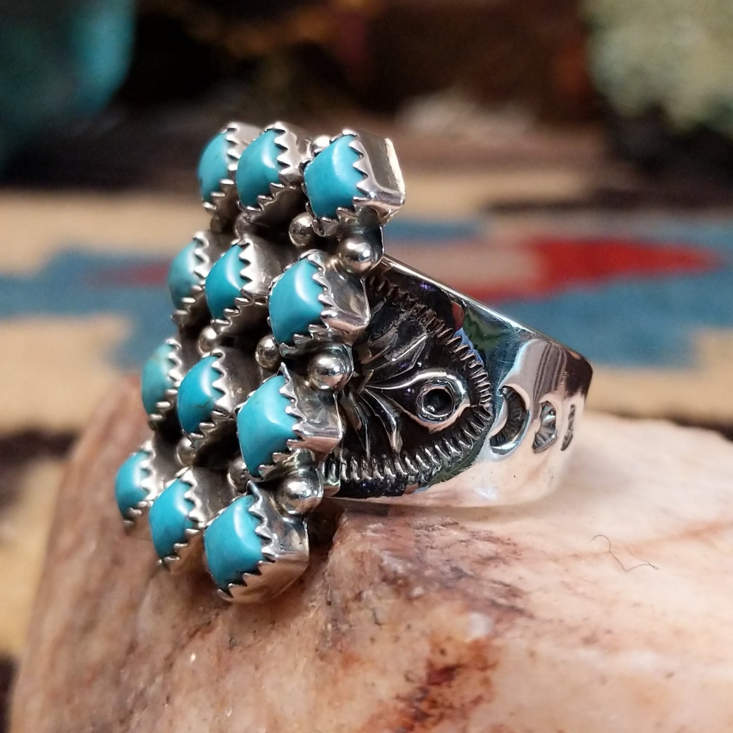 Sterling silver turquoise cluster ring by Verley Betone featuring multiple blue turquoise stones in a traditional Navajo floral-inspired design. Side view.