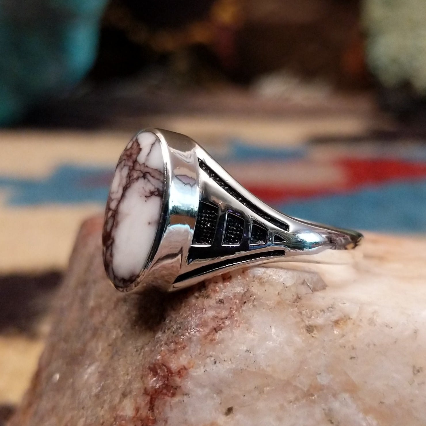 Navajo sterling silver ring with an oval Wild Horse stone featuring natural white and brown patterns in a classic Southwestern design. Side view.