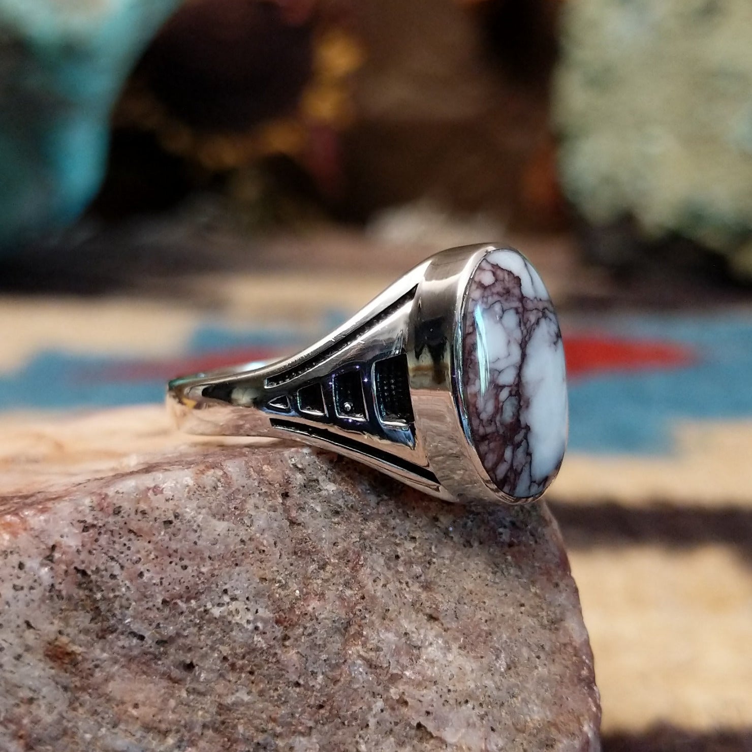 Navajo sterling silver ring with an oval Wild Horse stone featuring natural white and brown patterns in a classic Southwestern design. Side view.