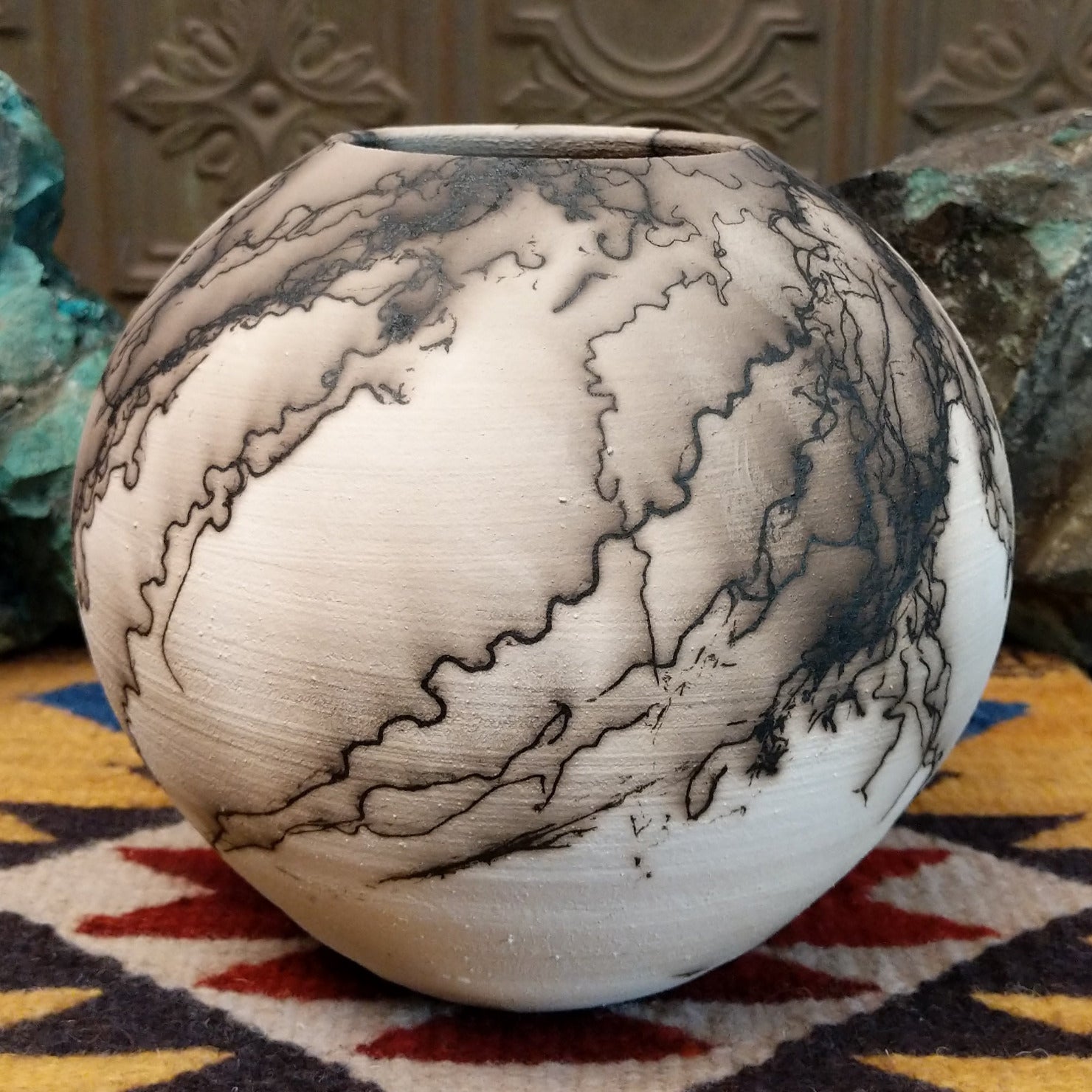 Medium globe-shaped white horsehair pottery vase by local artist Jim Calhoun featuring smoky organic patterns, a polished finish, and Southwestern handcrafted design.