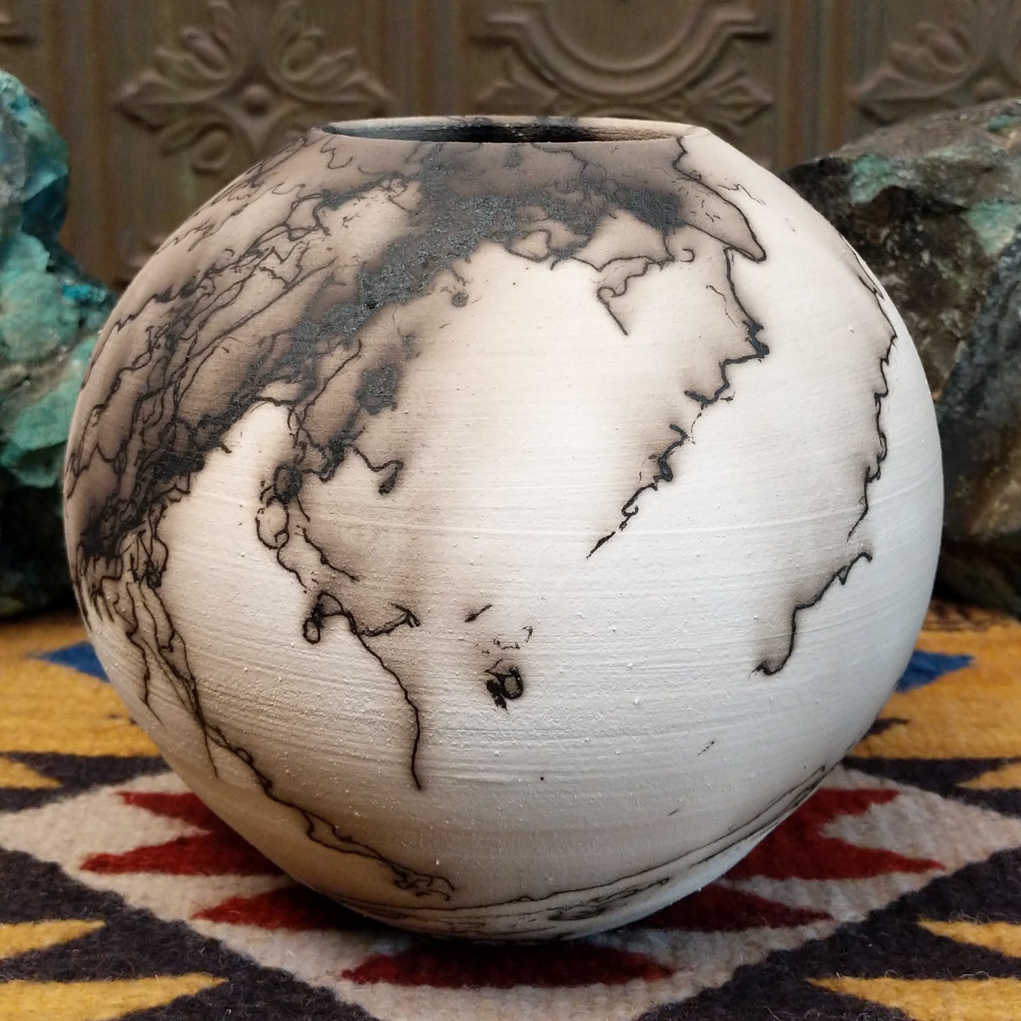 Medium globe-shaped white horsehair pottery vase by local artist Jim Calhoun featuring smoky organic patterns, a polished finish, and Southwestern handcrafted design.