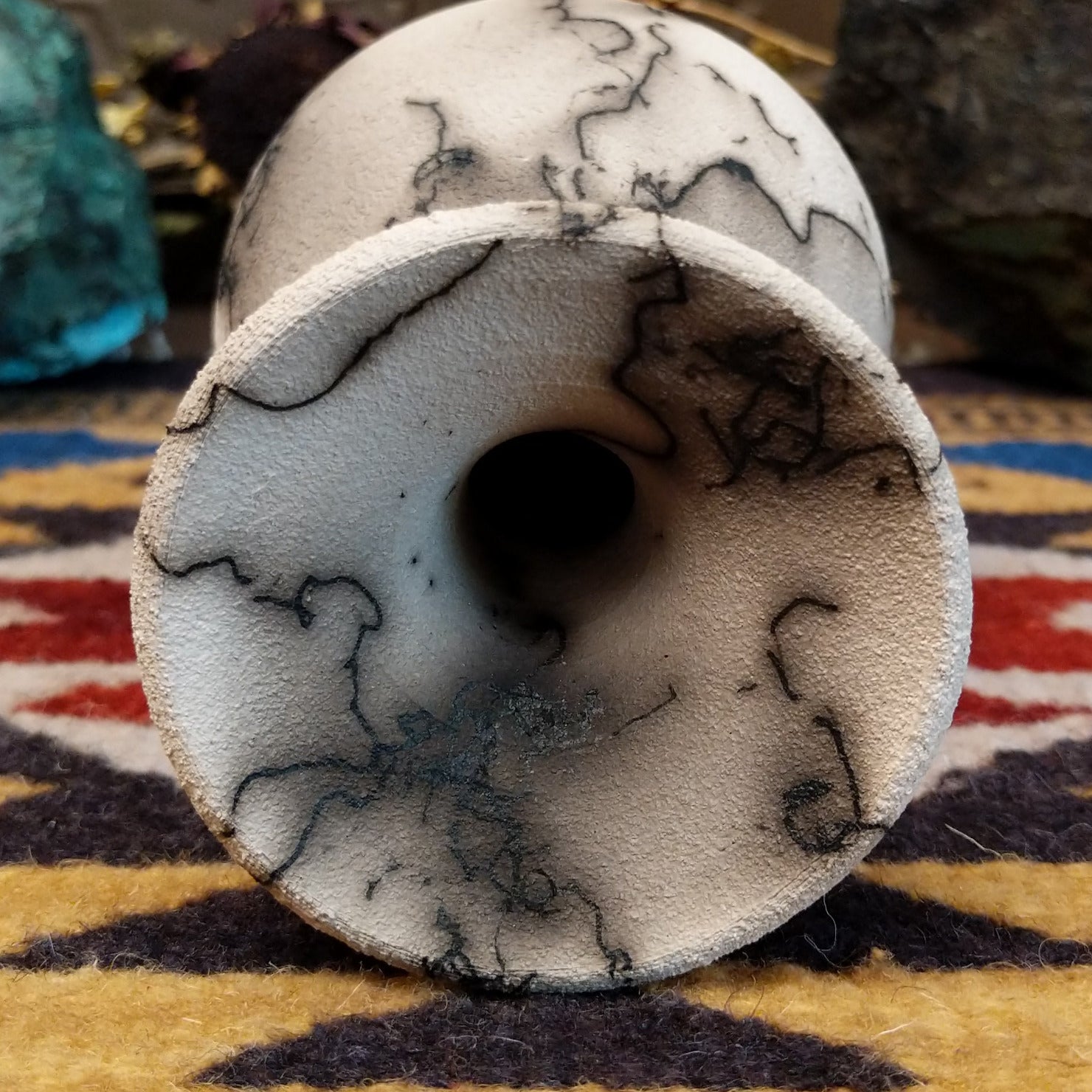 Small flared white horsehair pottery vase by local artist Jim Calhoun featuring smoky organic patterns, polished finish, and handcrafted Southwestern style. Top view.