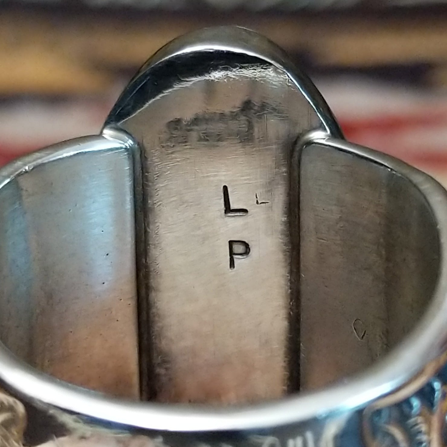 Sterling silver Navajo ovoid ring by L.P. featuring a polished White Buffalo stone set in a traditional handcrafted bezel. Artisan initials.