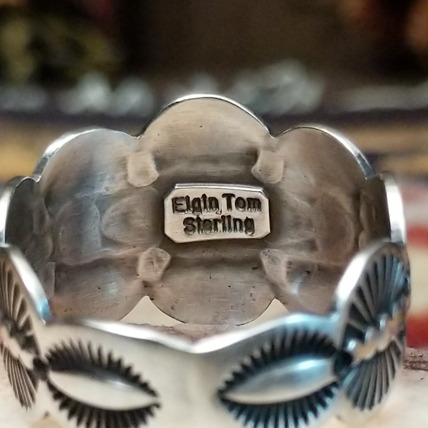 Handcrafted sterling silver scalloped ring by Elgin Tom featuring a polished finish and curved scalloped edges in a traditional Southwestern design. Artisan and Sterling Silver stamp.