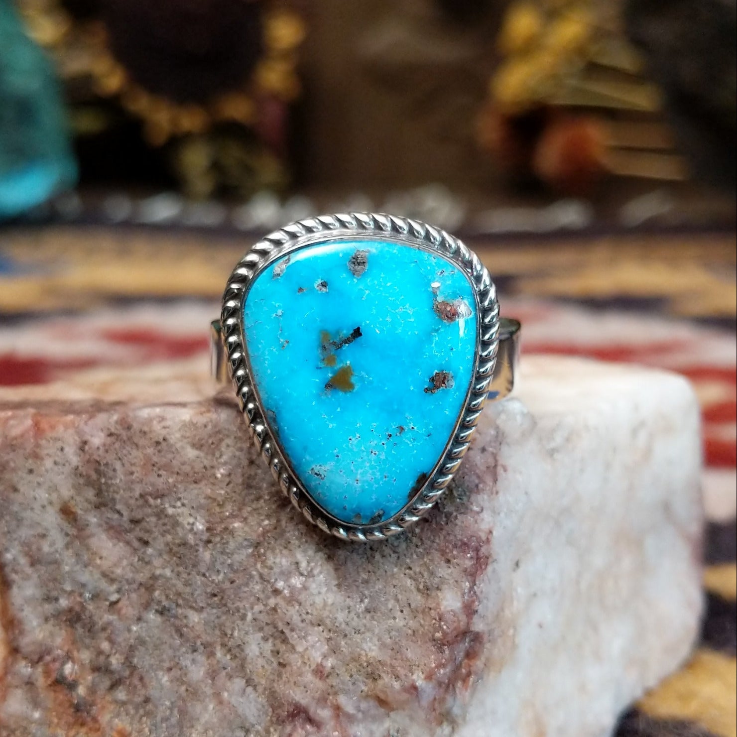 Handcrafted sterling silver ring by S.R. Chee featuring a triangular turquoise stone with traditional Southwestern Native American silver detailing.