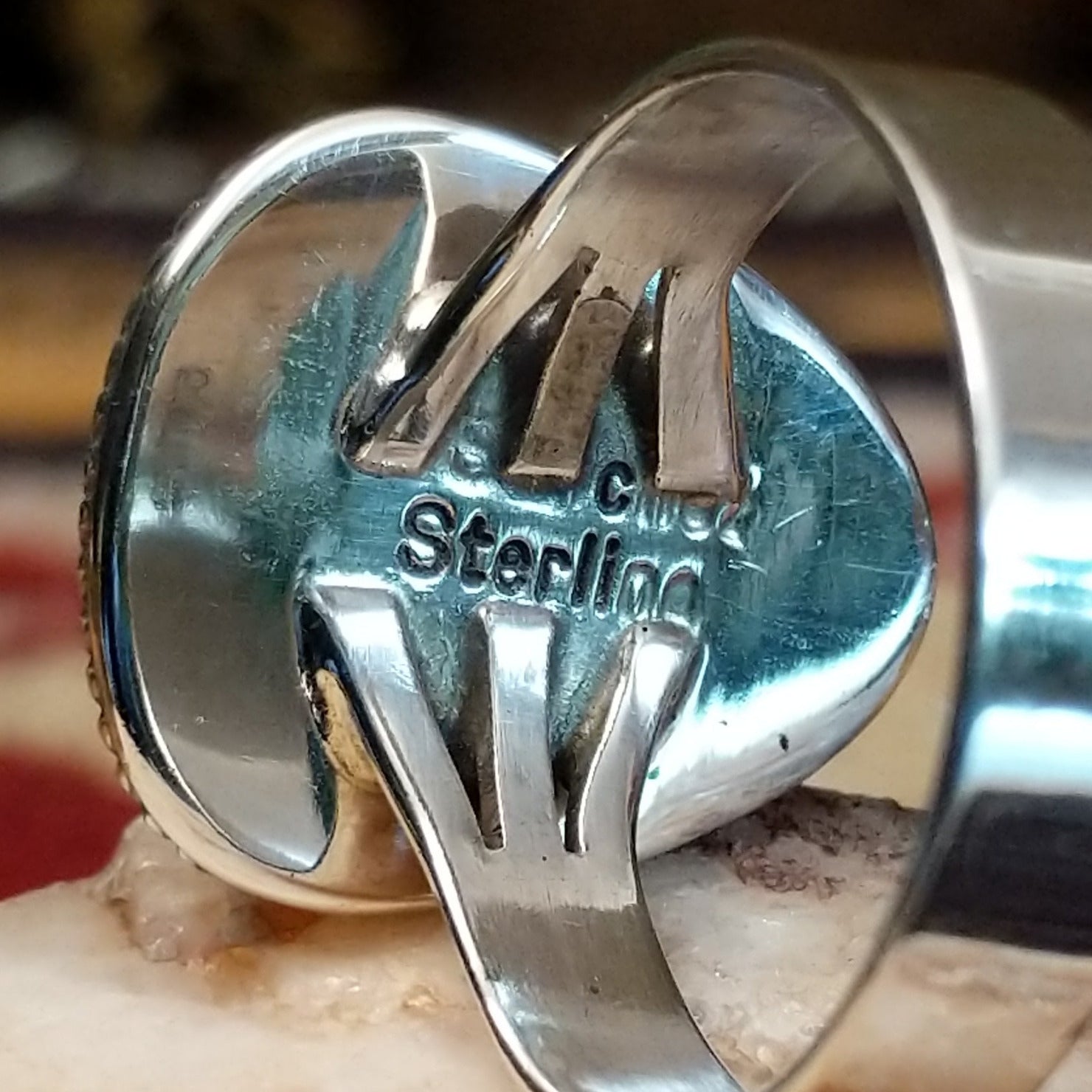 Handcrafted sterling silver ring by S.R. Chee featuring a triangular turquoise stone with traditional Southwestern Native American silver detailing. Artisan and Sterling Silver stamp.