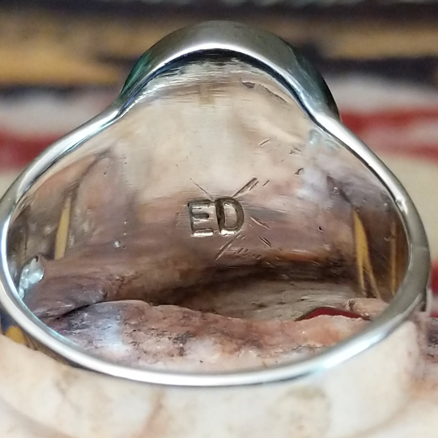 Handcrafted sterling silver oval ring by Eugene Davy featuring lapis, turquoise, charoite, mother of pearl, and gaspeite in a multistone Southwestern design. Artisan stamp.