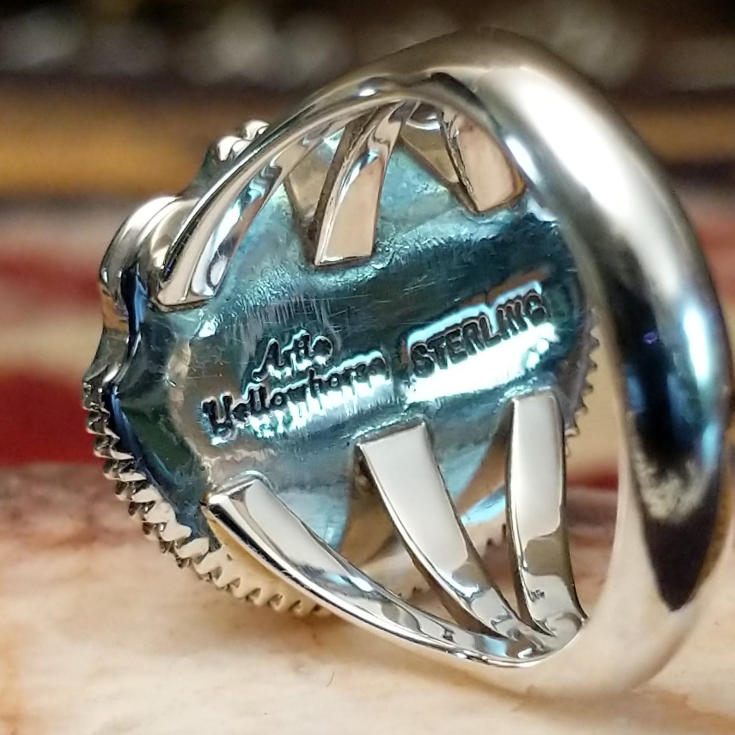 Handcrafted sterling silver ring by Artie Yellowhorse featuring a warm amber stone in a polished Southwestern Native American design. Artisan and Sterling Silver stamp.